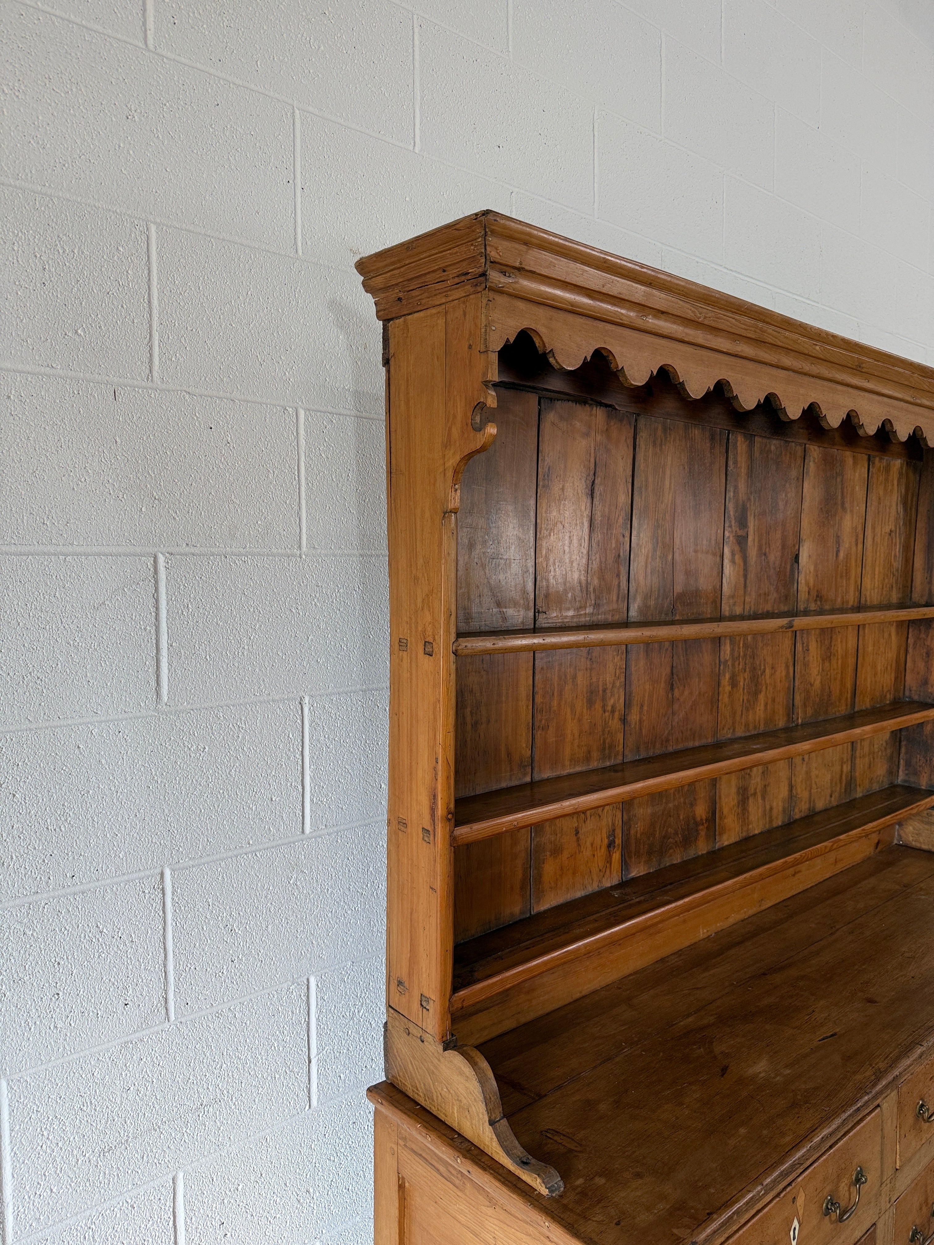 Antique English pine kitchen dresser with paneled doors and detailed trim work