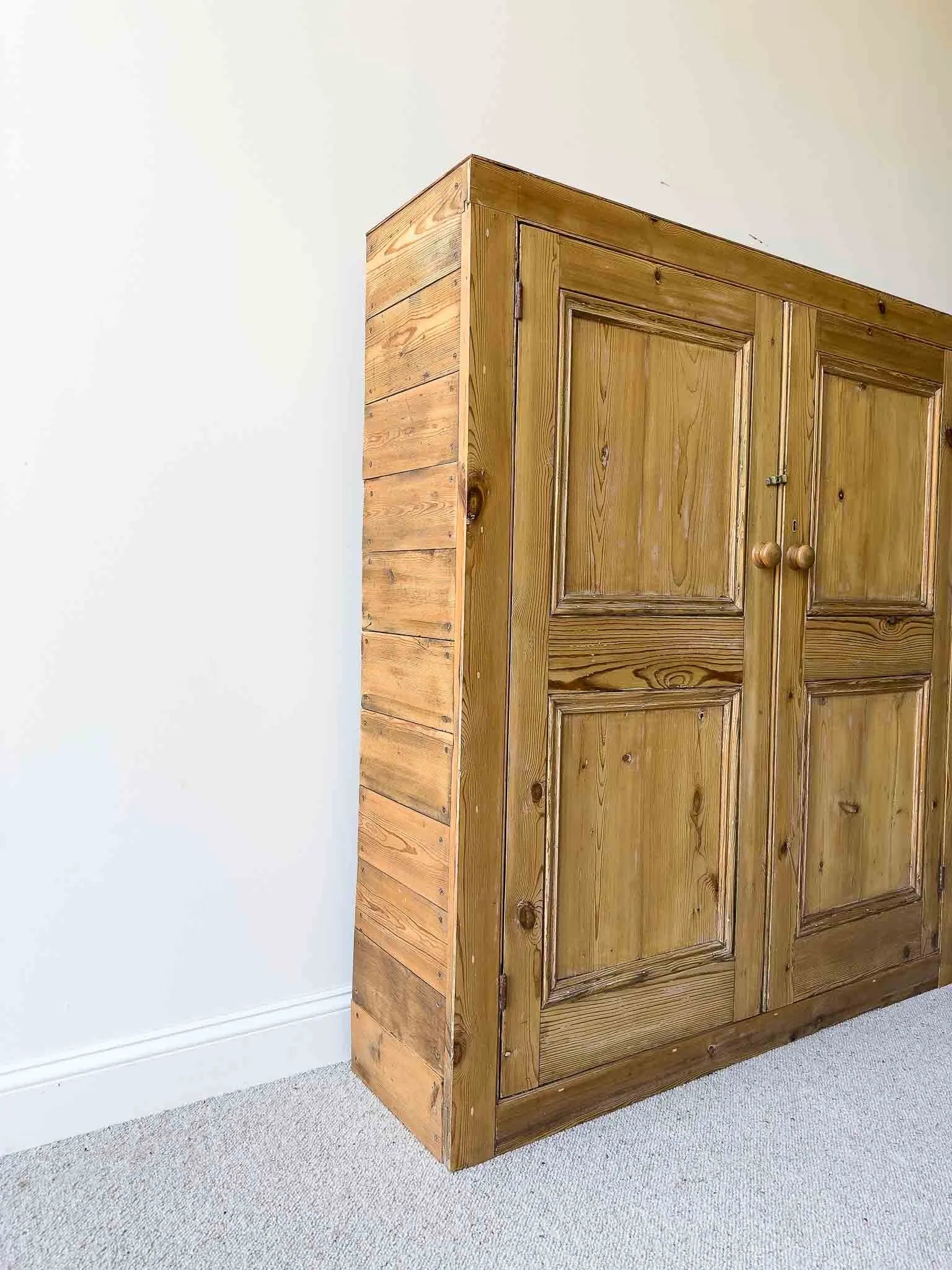A large antique pine cupboard