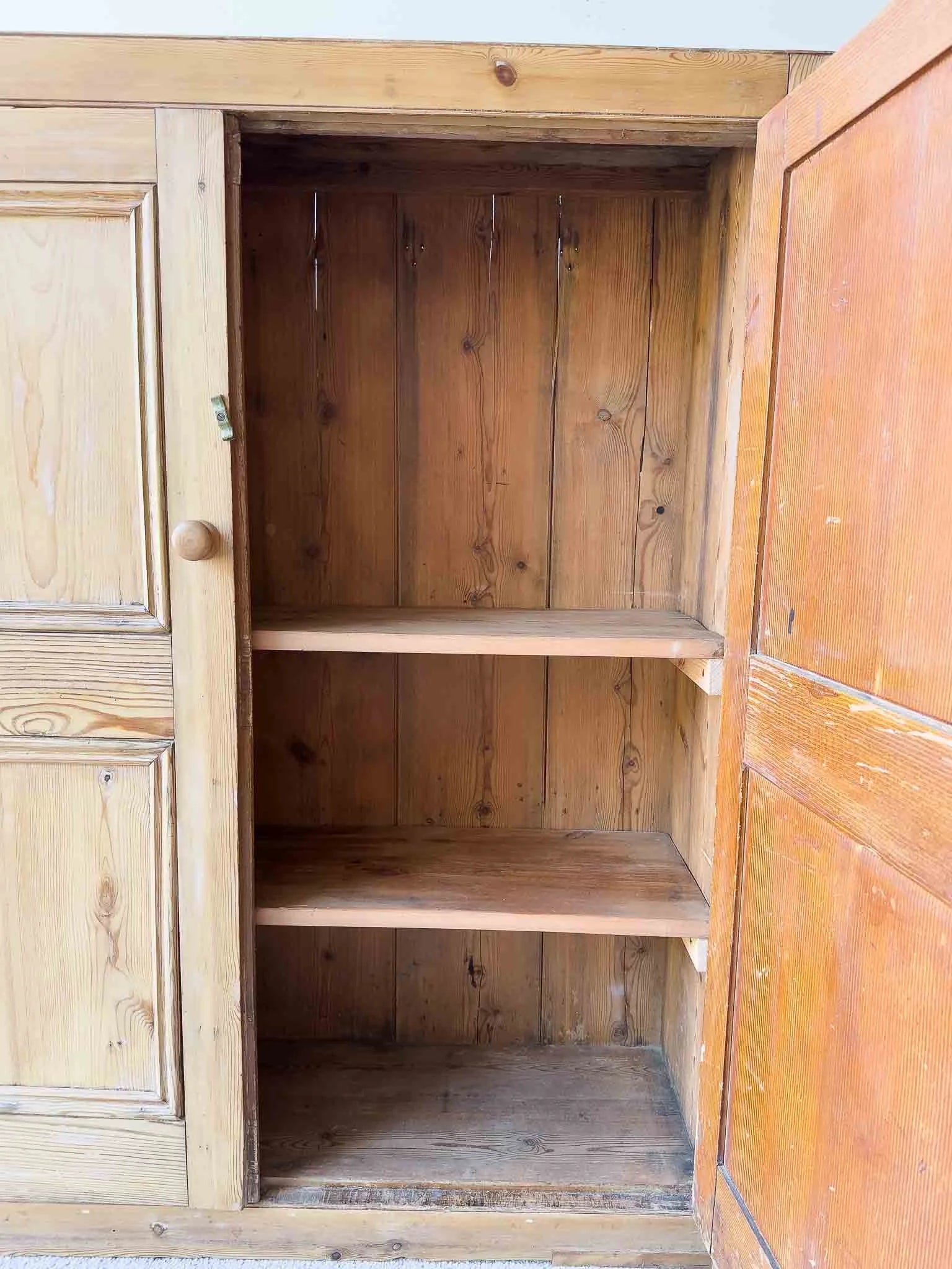 A large antique pine cupboard