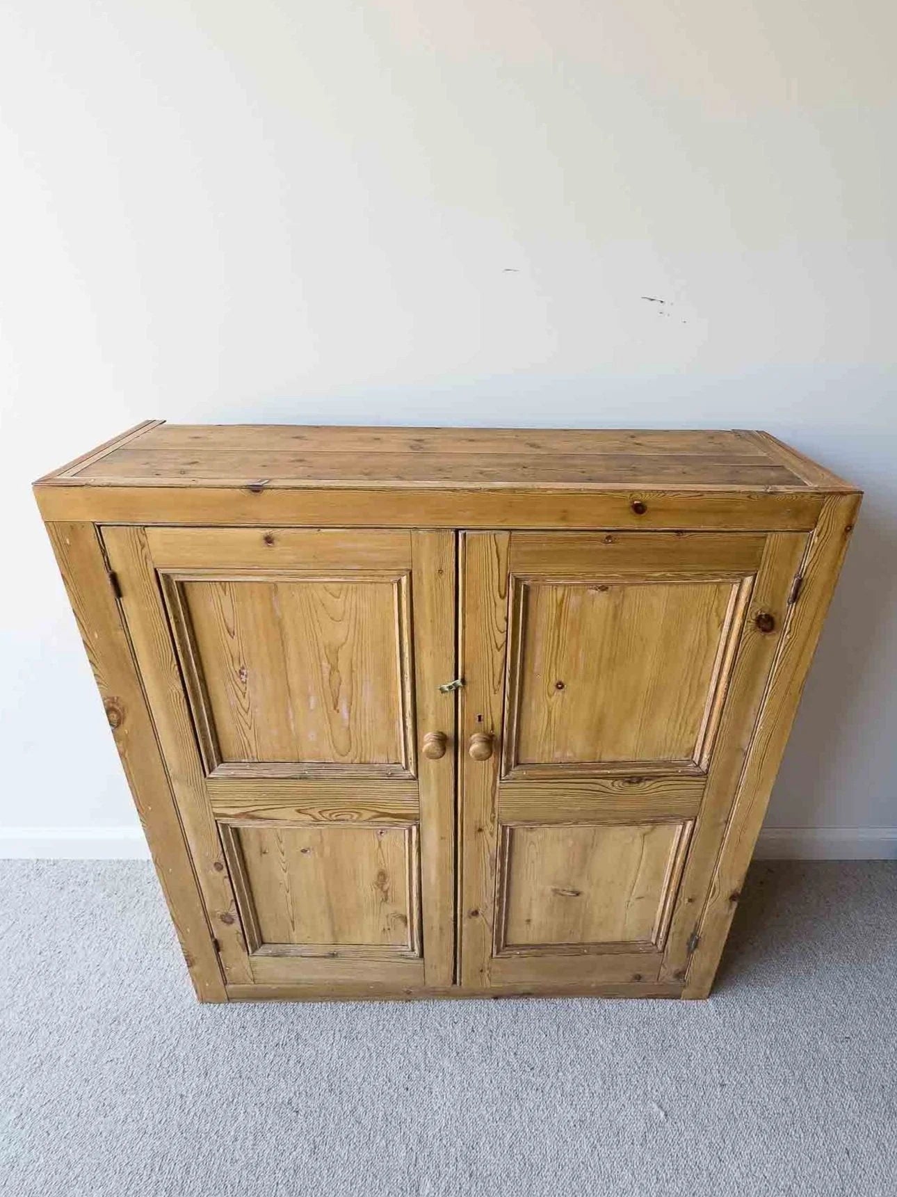 A large antique pine cupboard