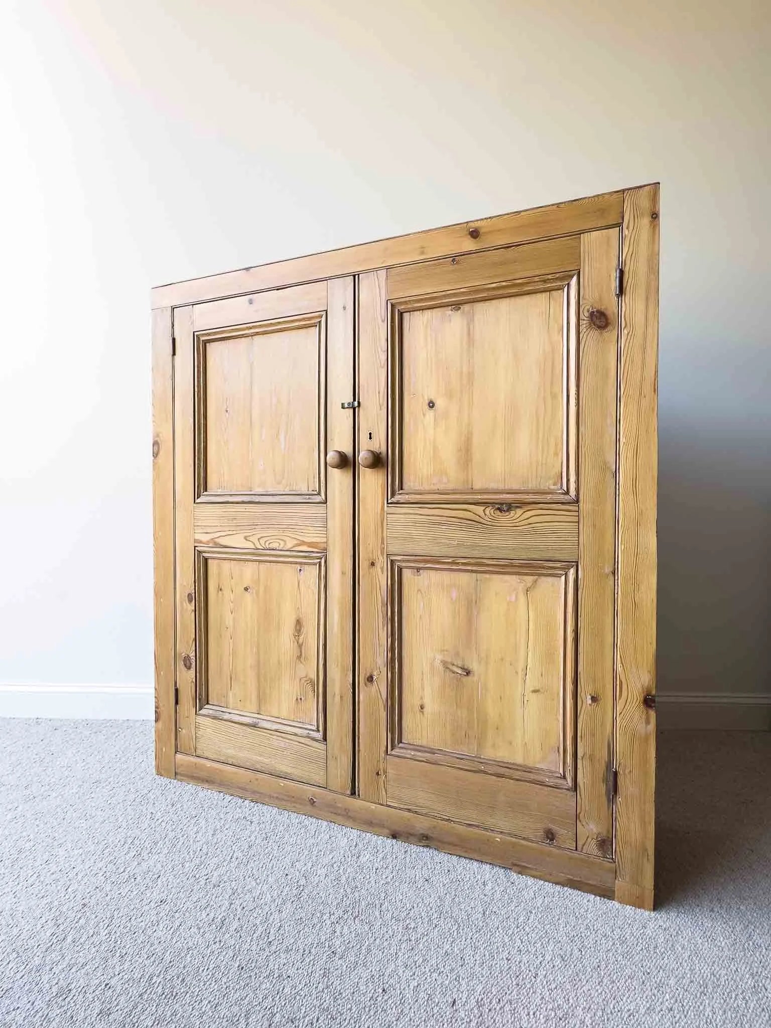 A large antique pine cupboard