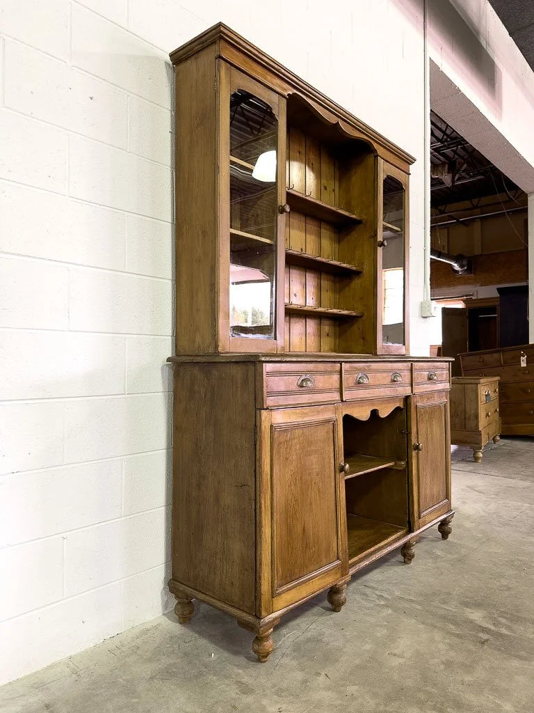 Antique European hutch with glass doors and a plate rack