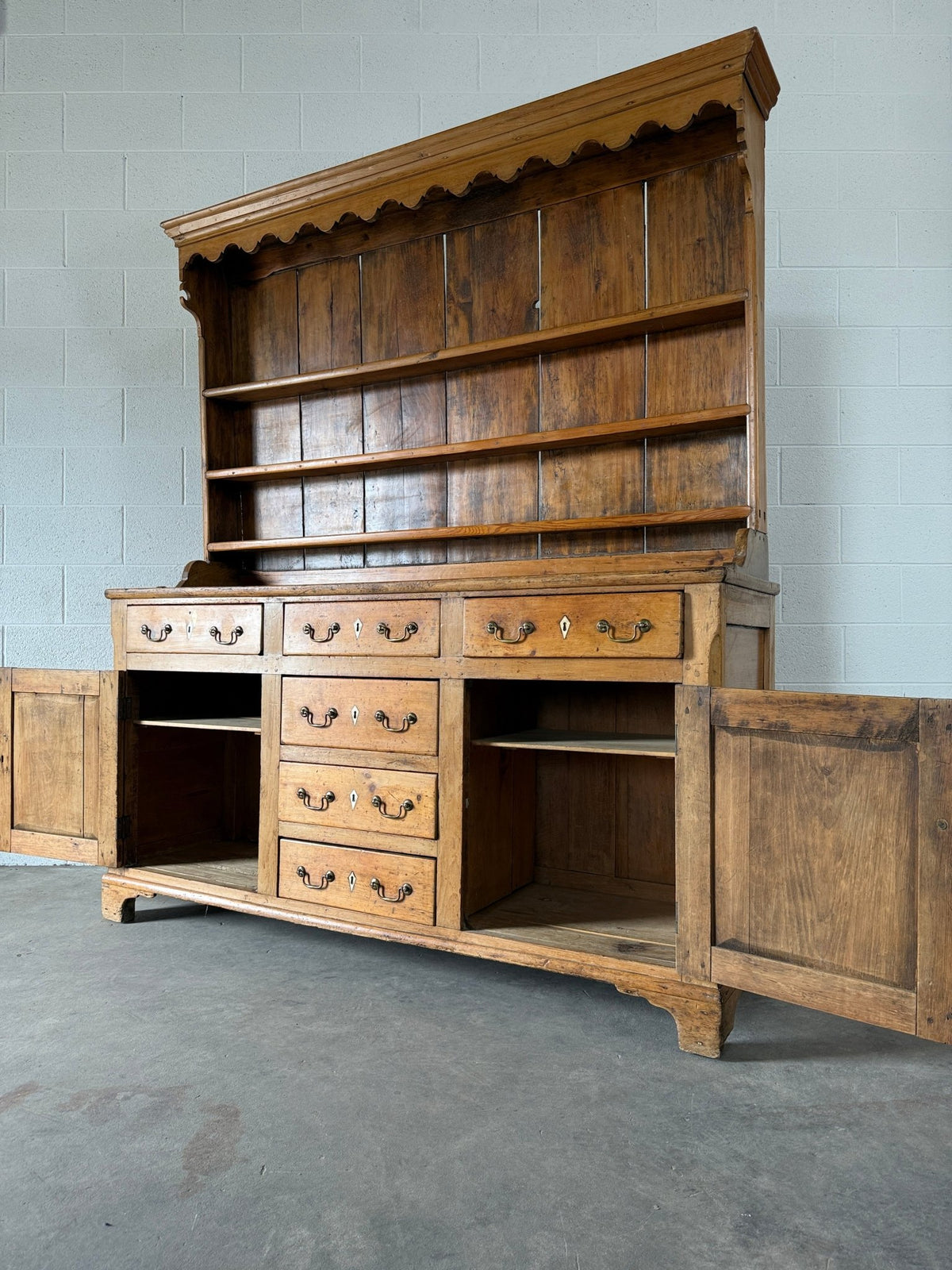 Antique English pine kitchen dresser with paneled doors and detailed trim work - House on Horizon