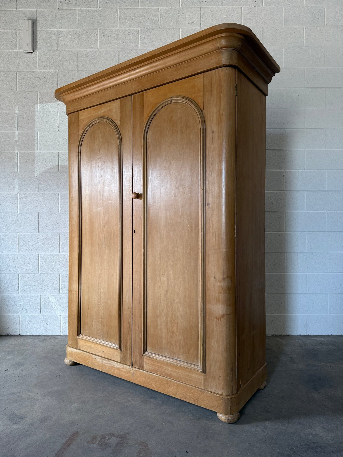 Antique English pine wardrobe with arched panel doors and fitted interior - House on Horizon