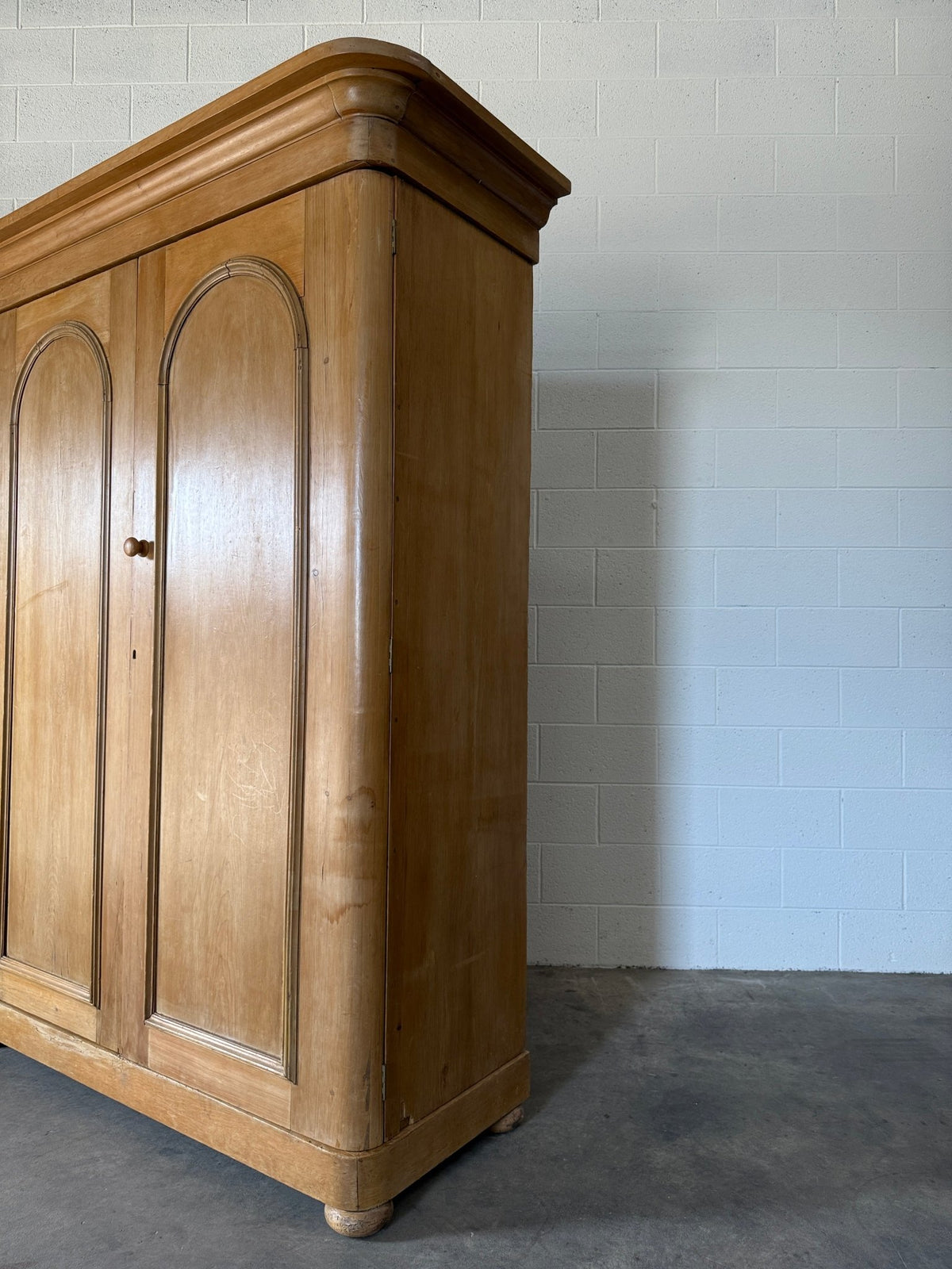 Antique English pine wardrobe with arched panel doors and fitted interior - House on Horizon