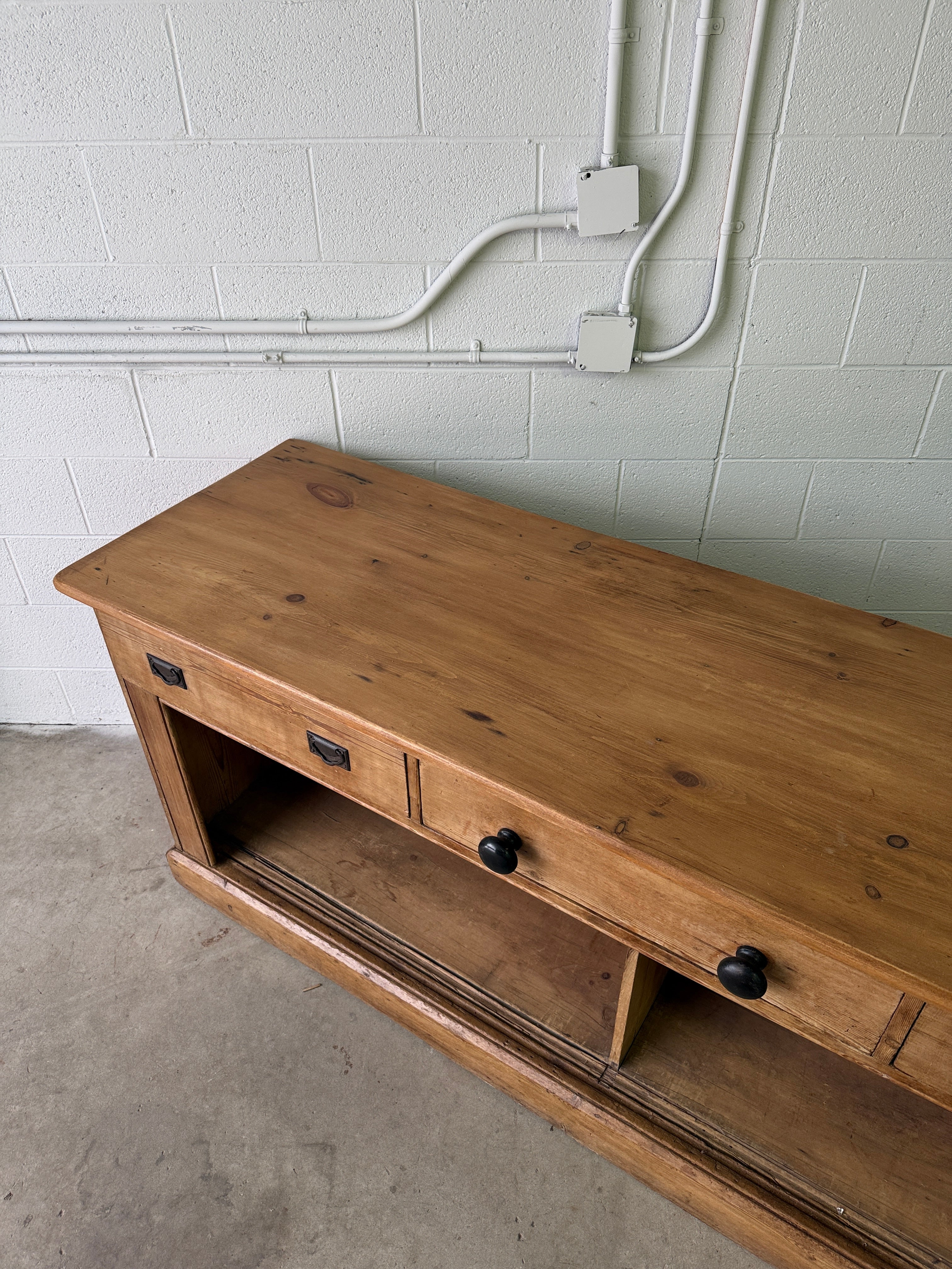 Antique English pine sideboard with open storage