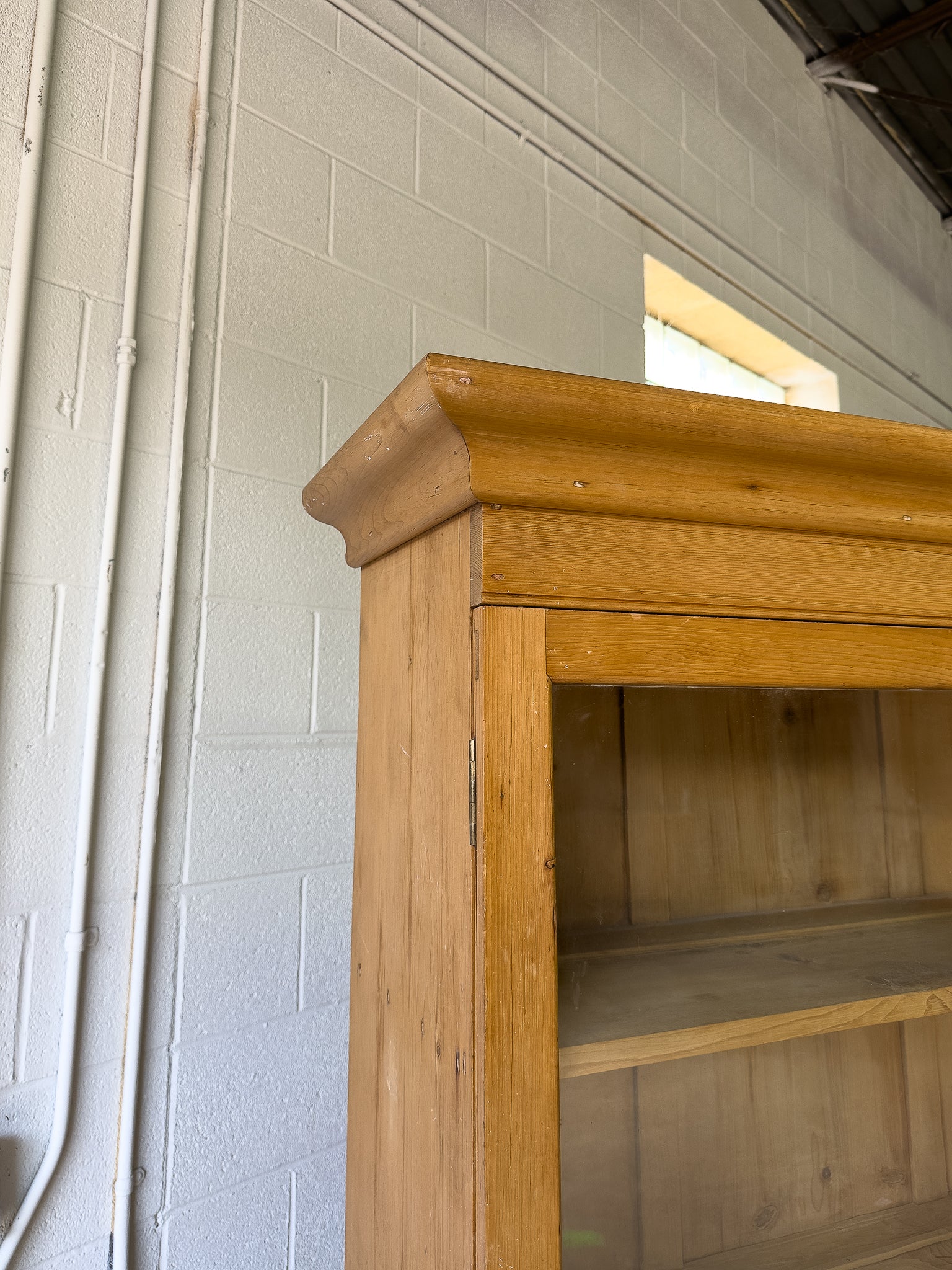 Antique English pine cupboard with wavy glass