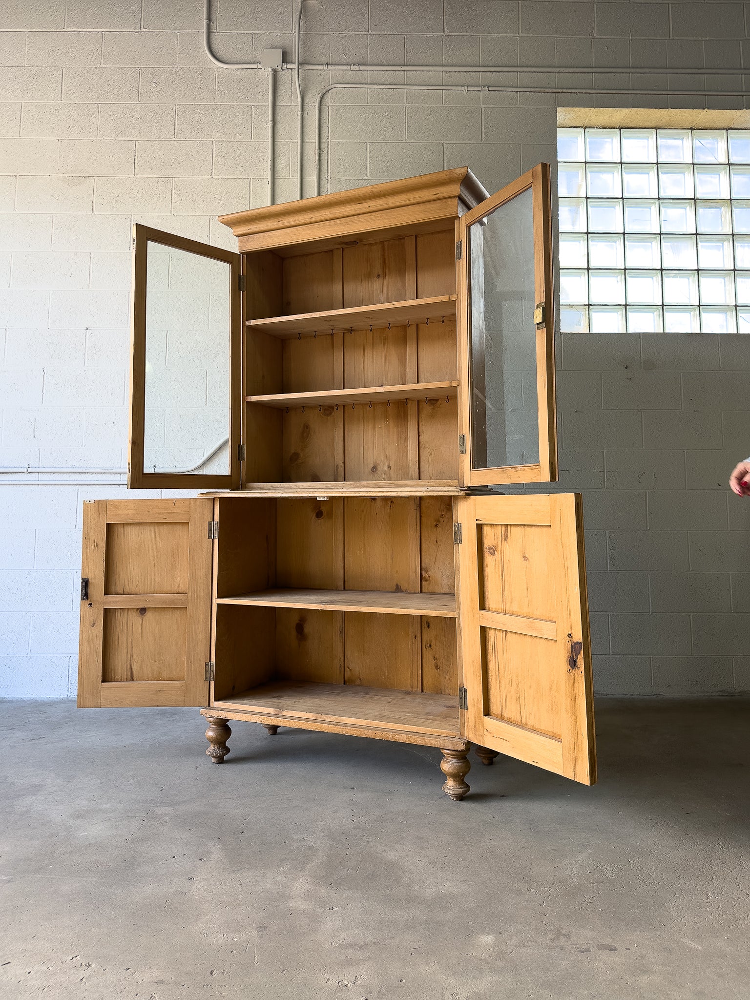 Antique English pine cupboard with wavy glass