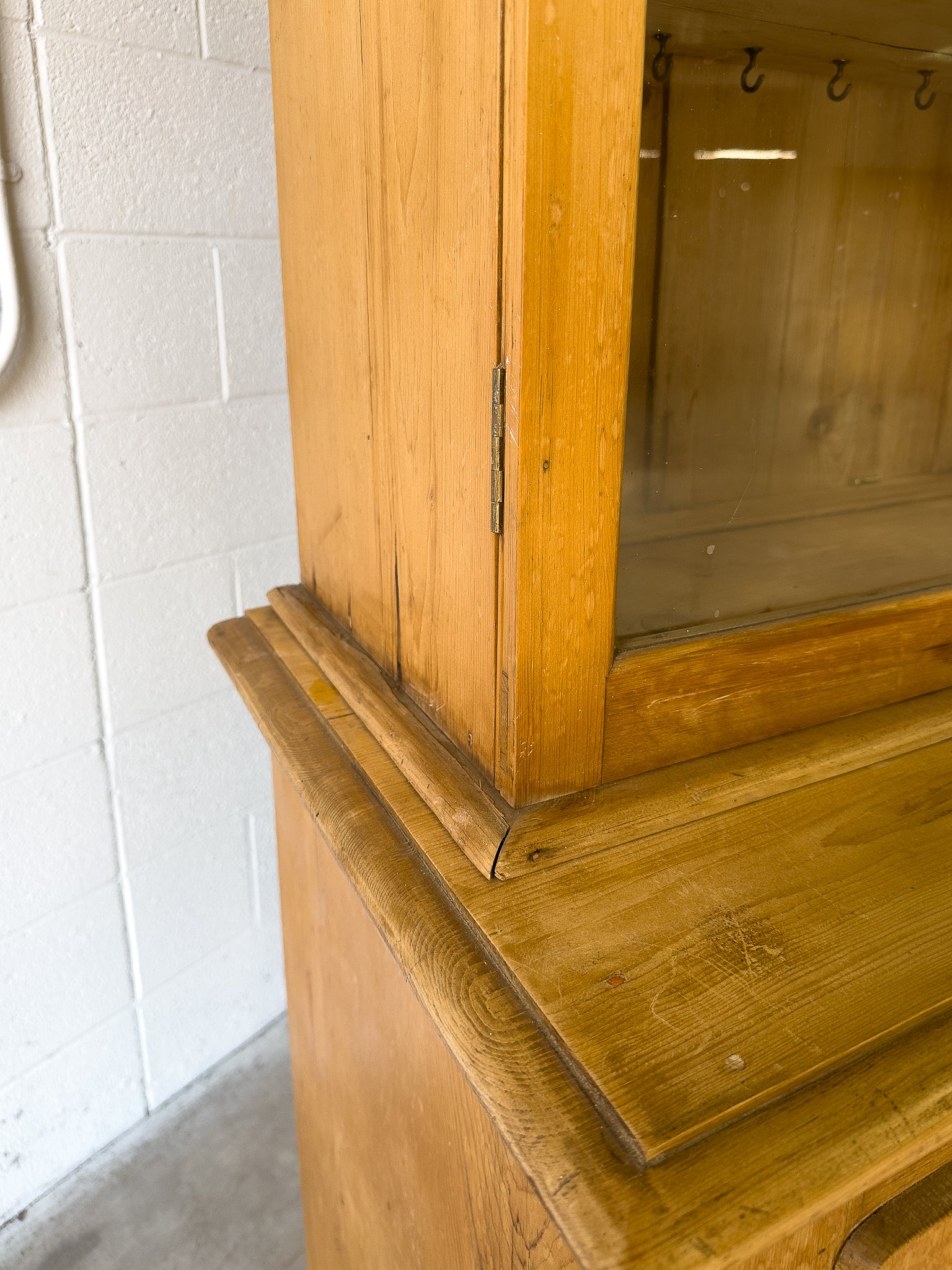 Antique English pine cupboard with wavy glass