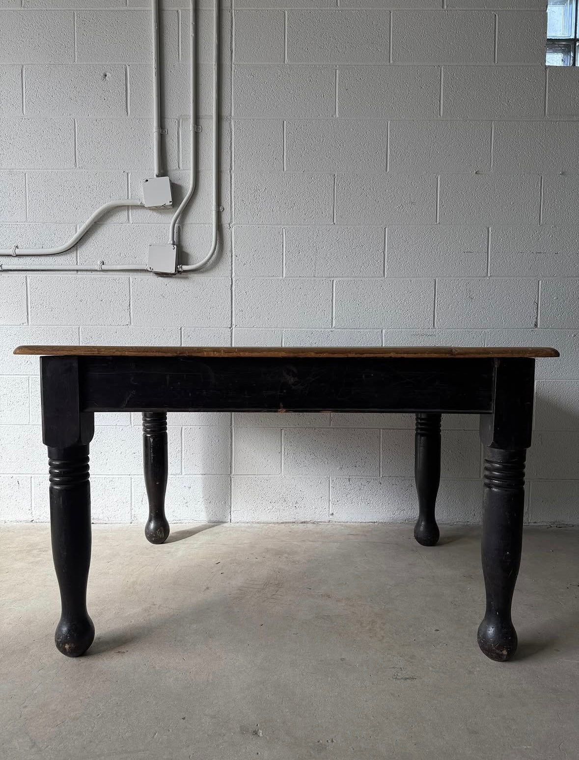 Antique black pine table with turned legs