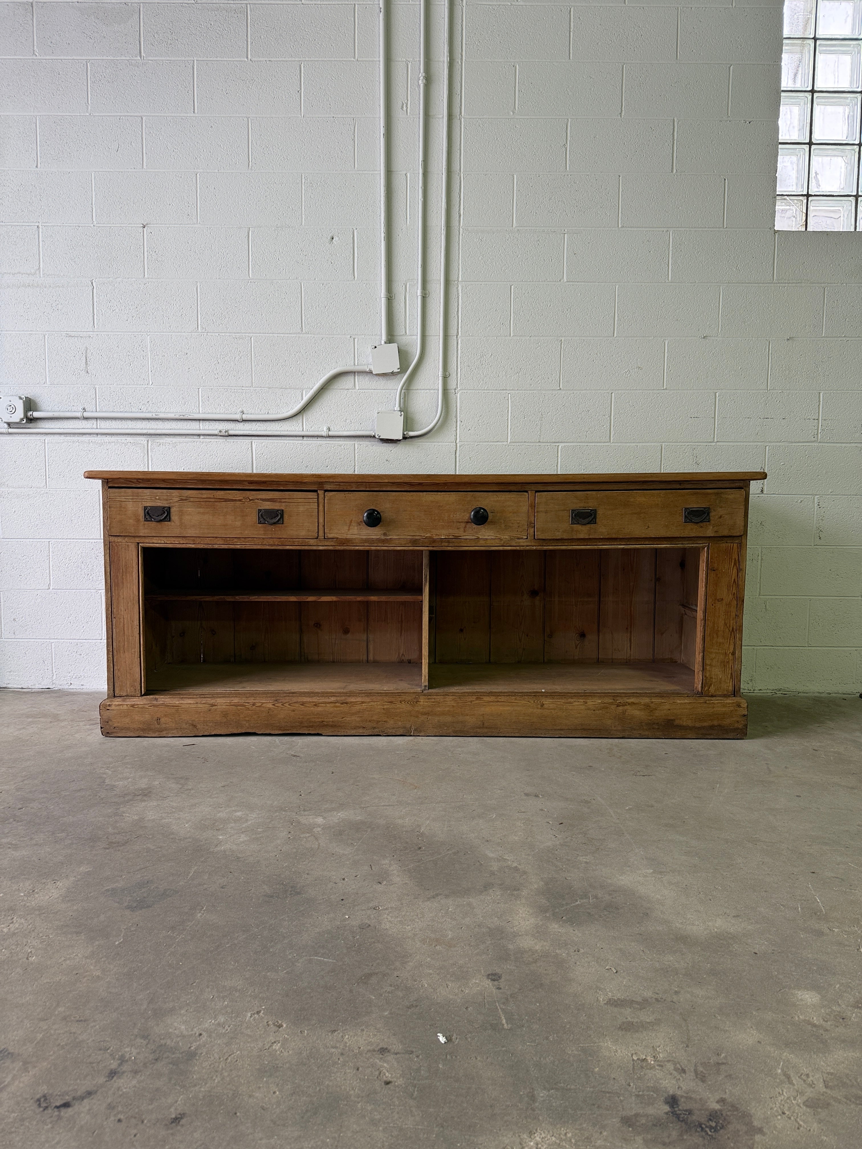 Antique English pine sideboard with open storage