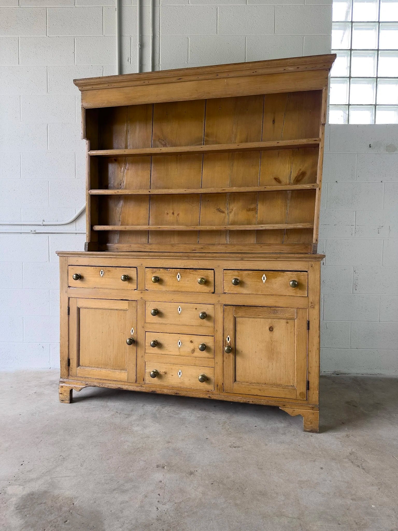 Antique English kitchen dresser with warm patina