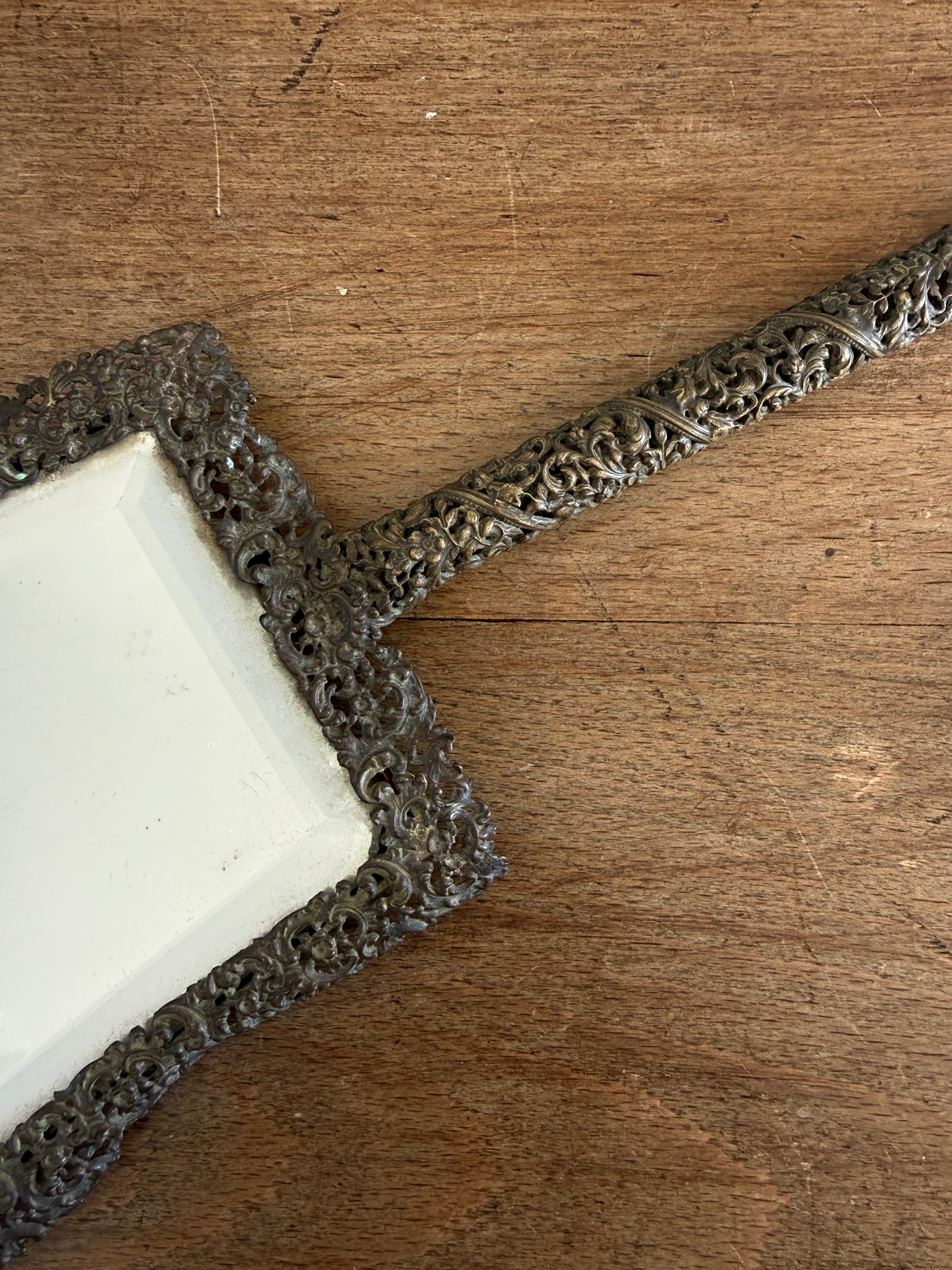 Antique hand mirror in a metal frame