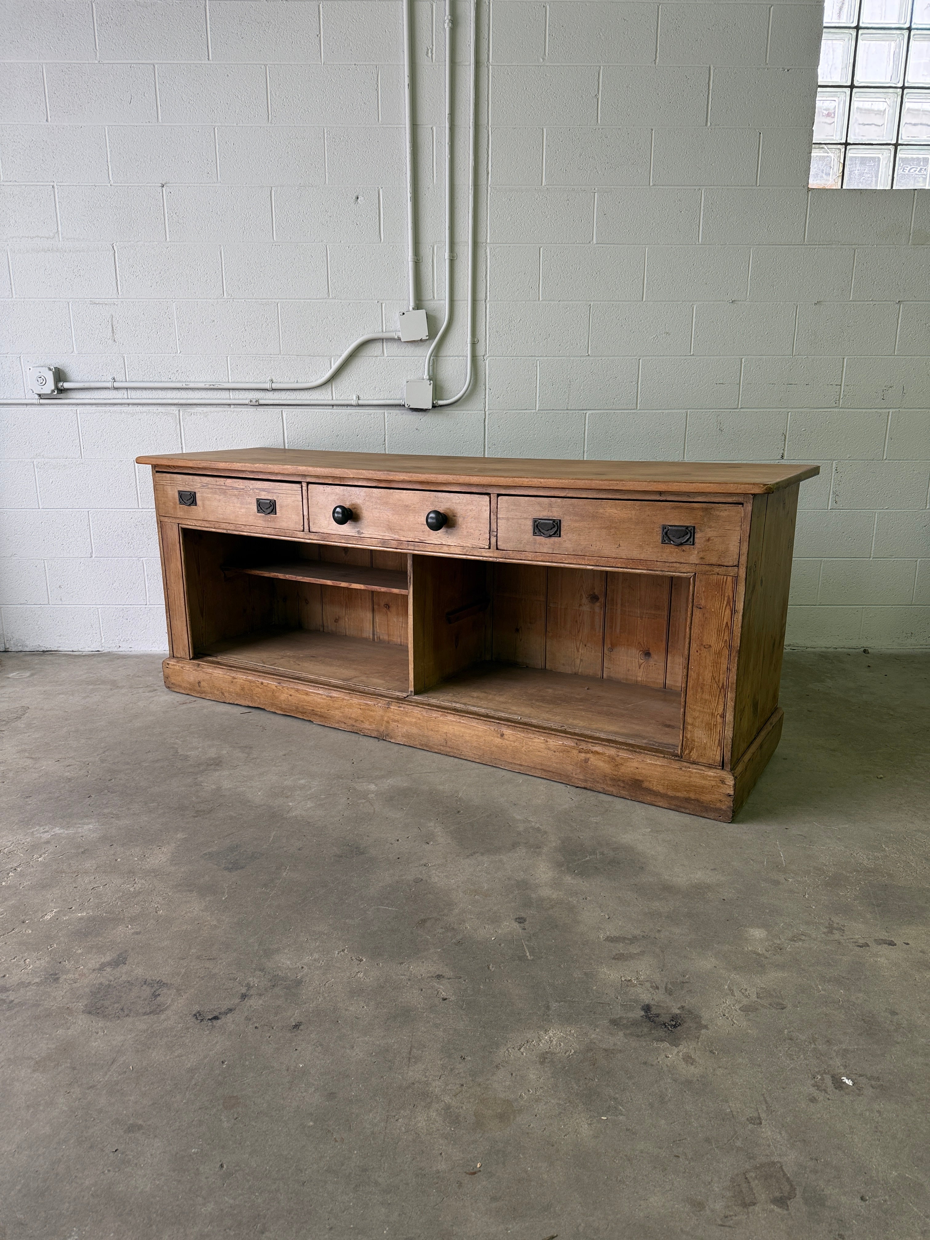 Antique English pine sideboard with open storage