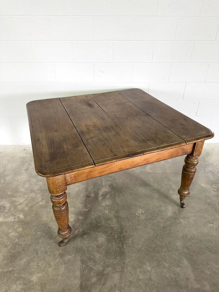 Square English breakfast table with turned legs and castors