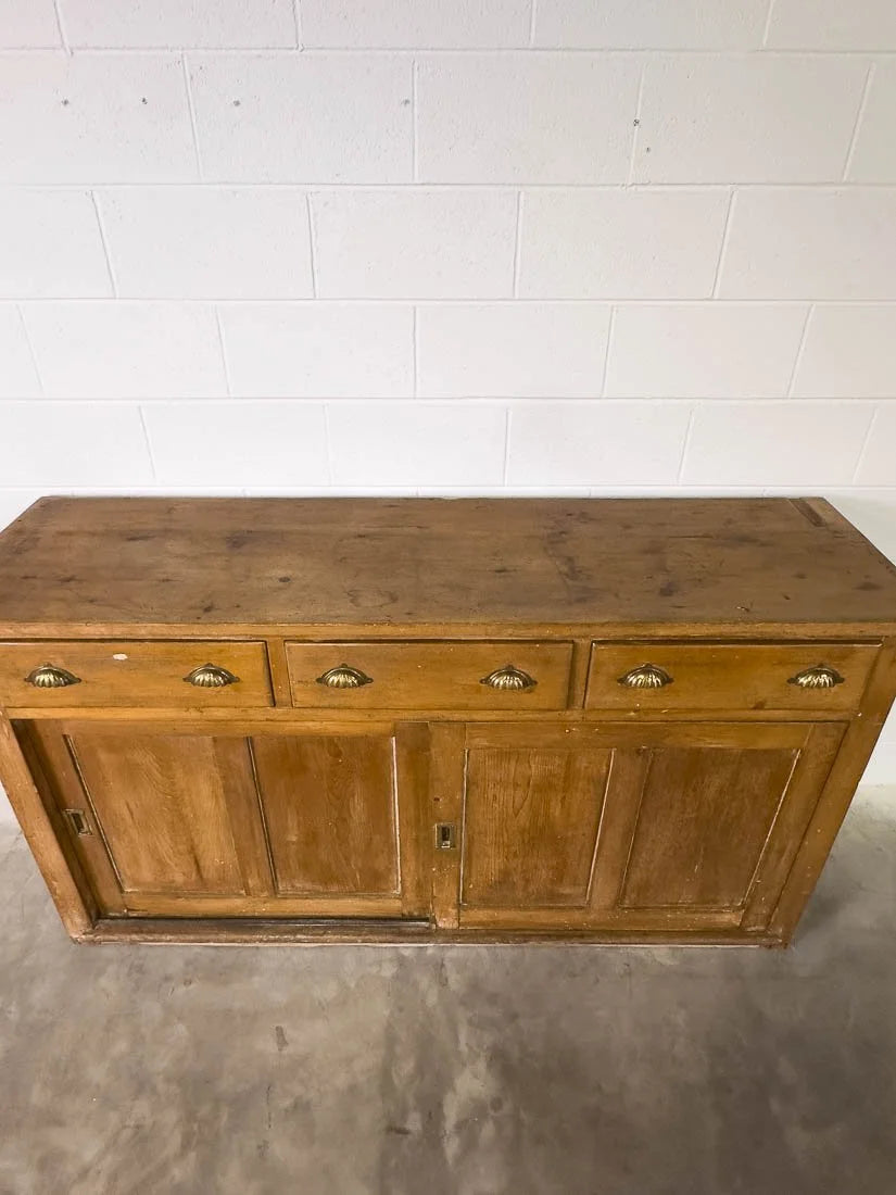 English pine sideboard with sliding doors and brass hardware