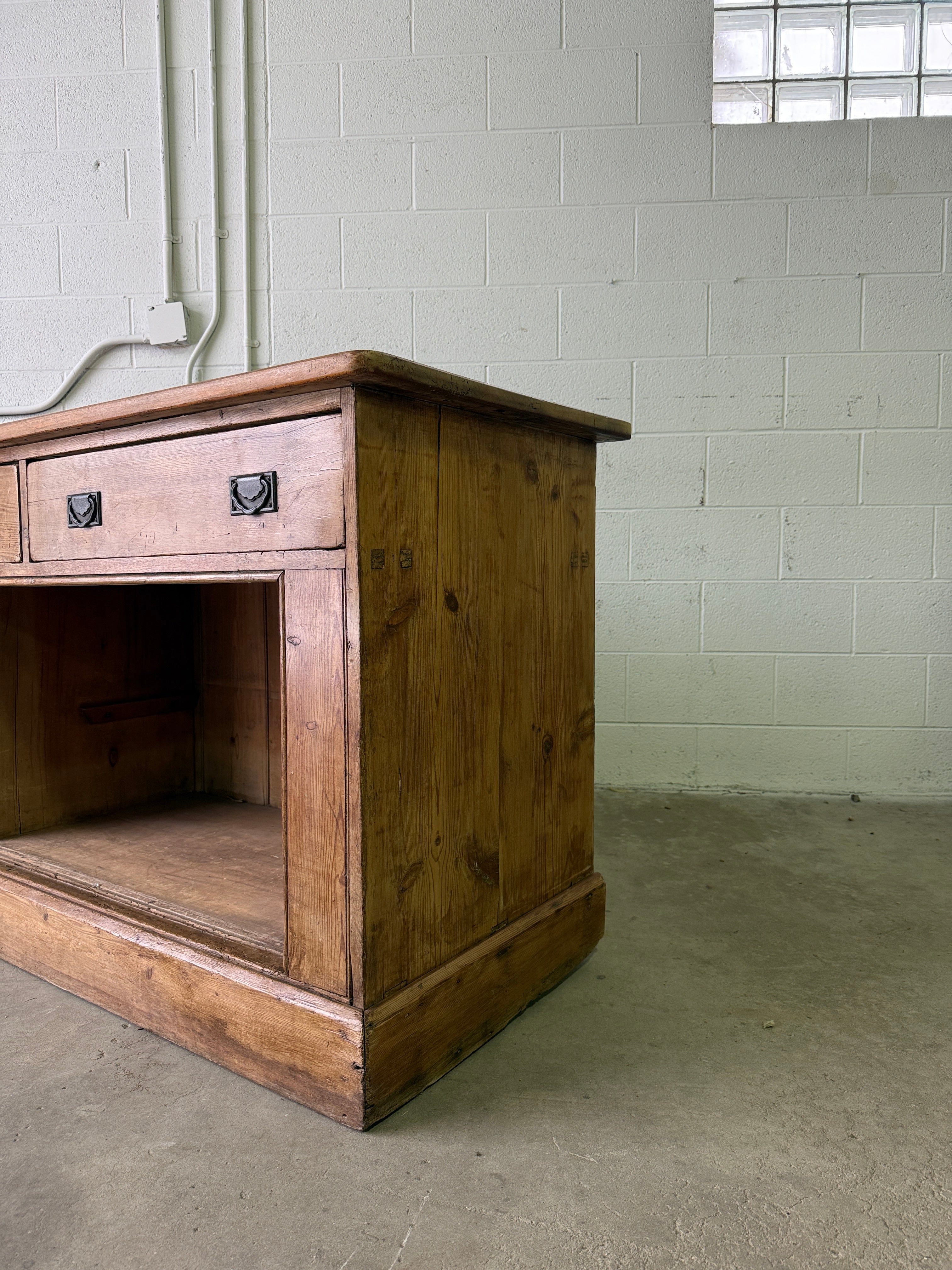 Antique English pine sideboard with open storage
