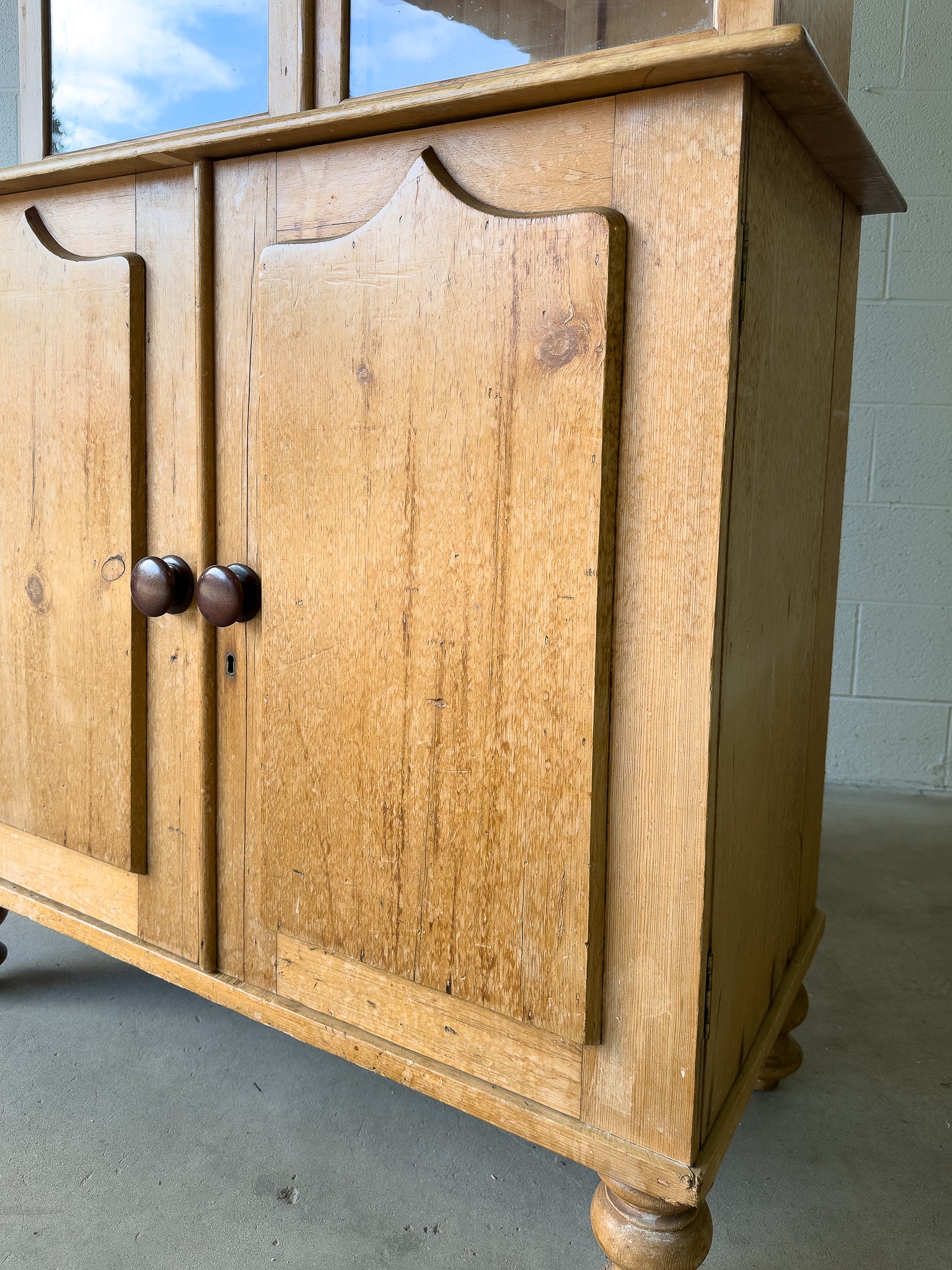 Antique English pine cupboard with wavy glass