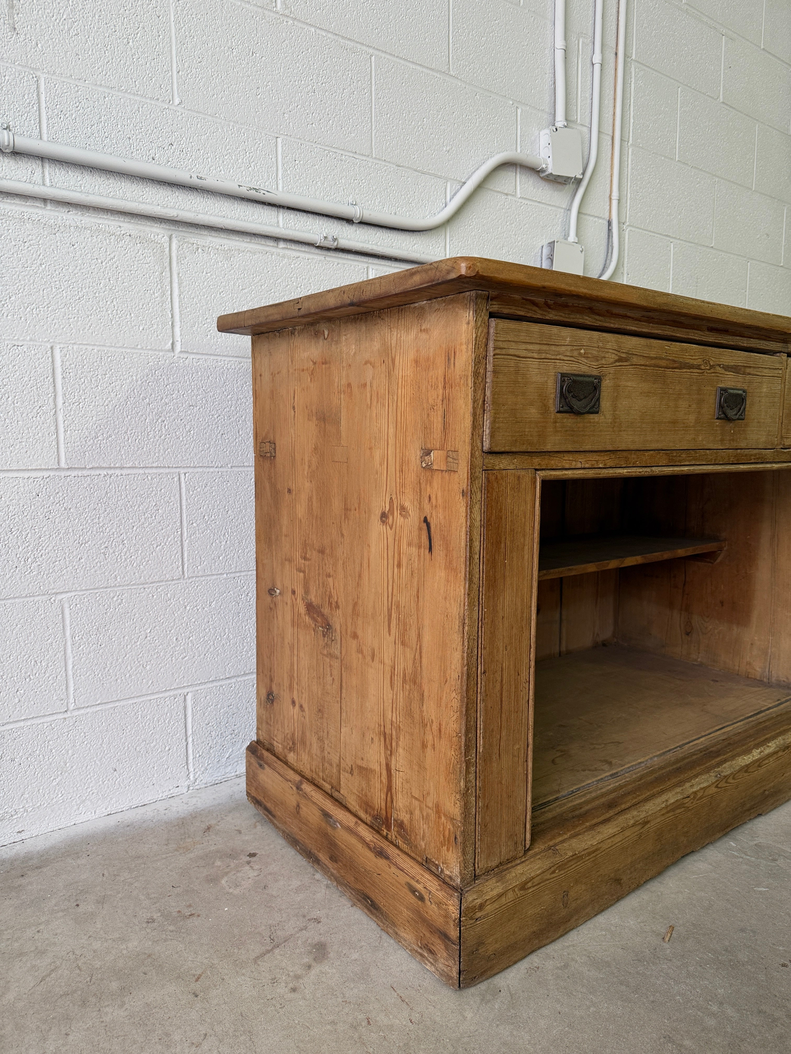 Antique English pine sideboard with open storage