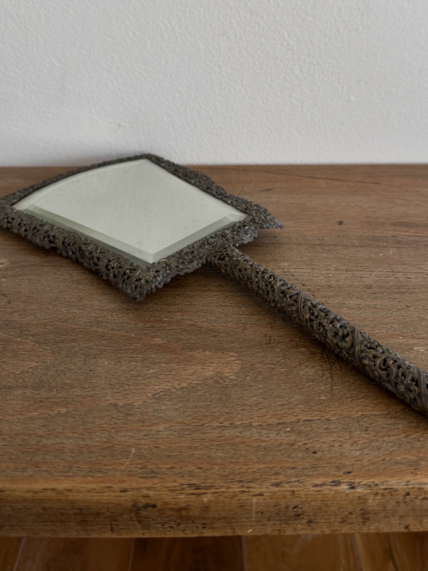 Antique hand mirror in a metal frame