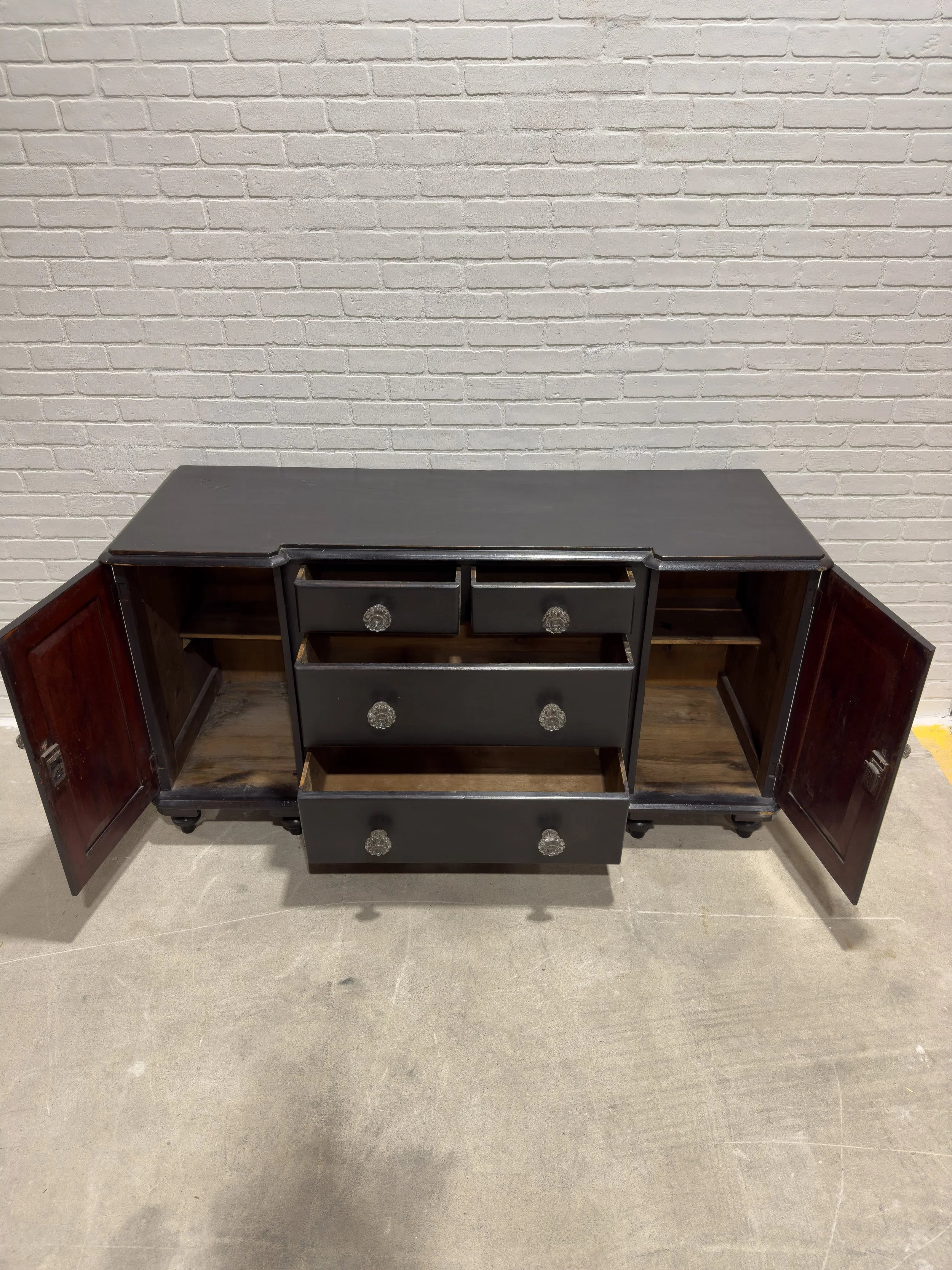 Ebonized English sideboard with glass knobs