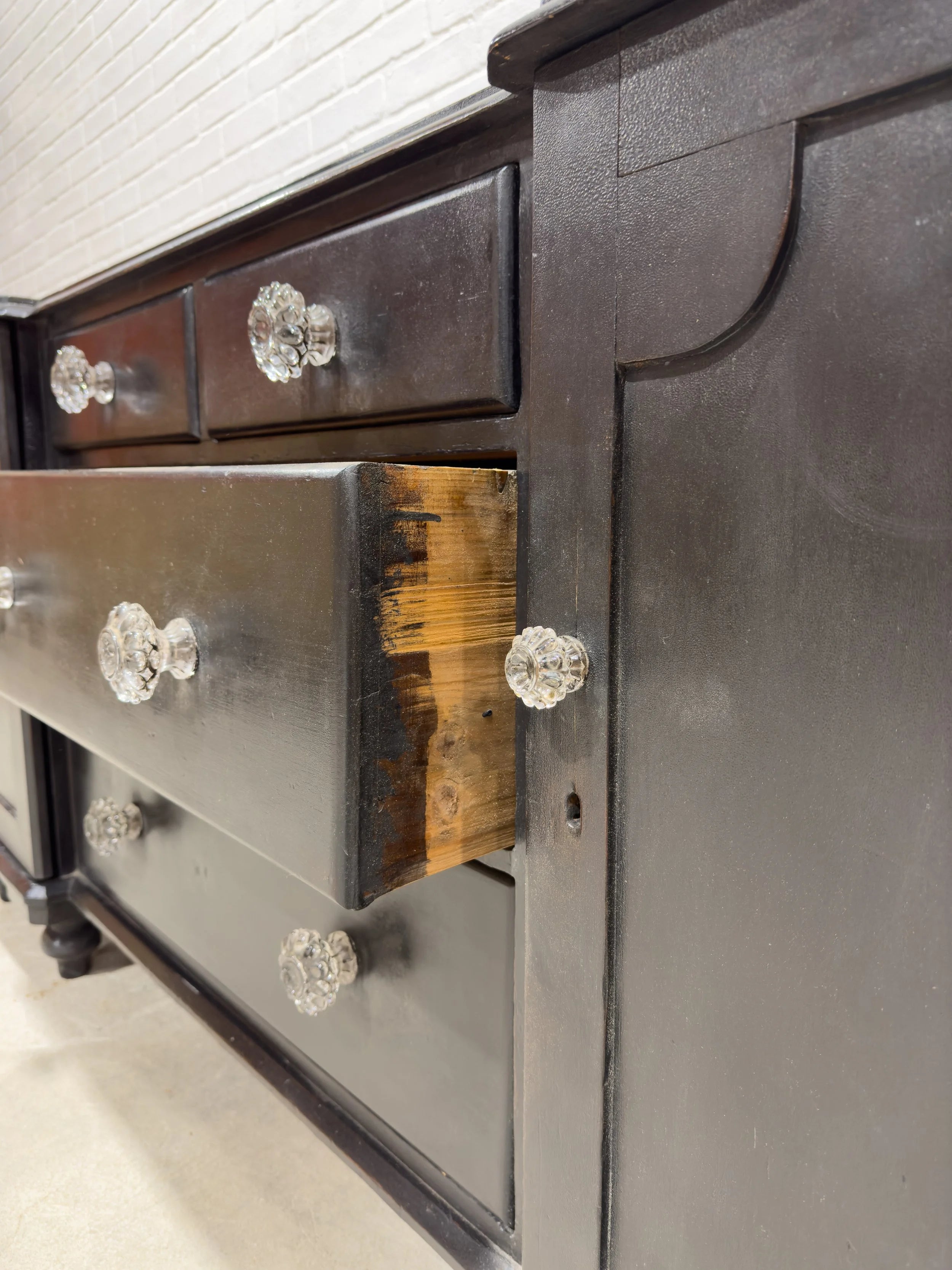 Ebonized English sideboard with glass knobs