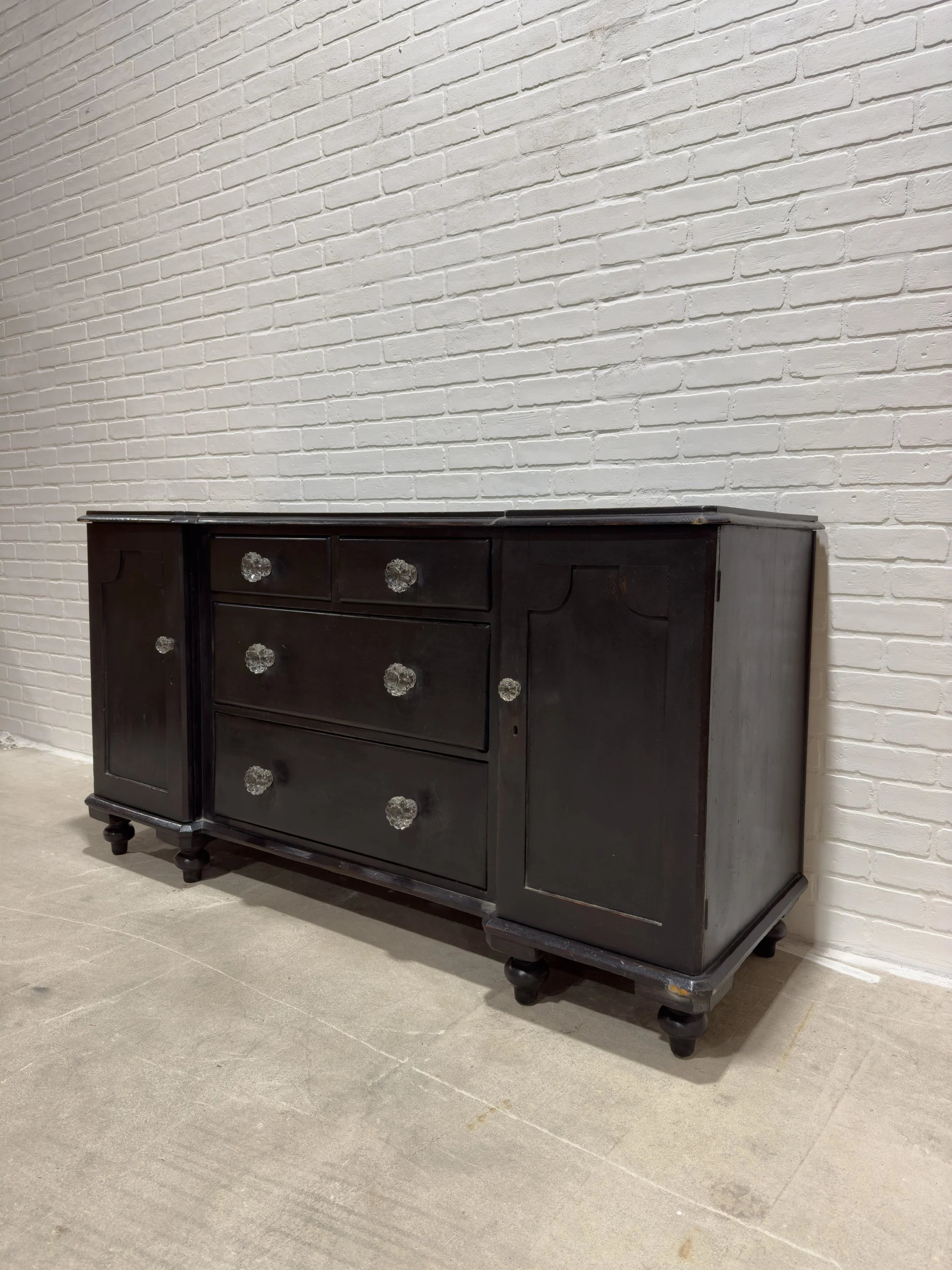 Ebonized English sideboard with glass knobs