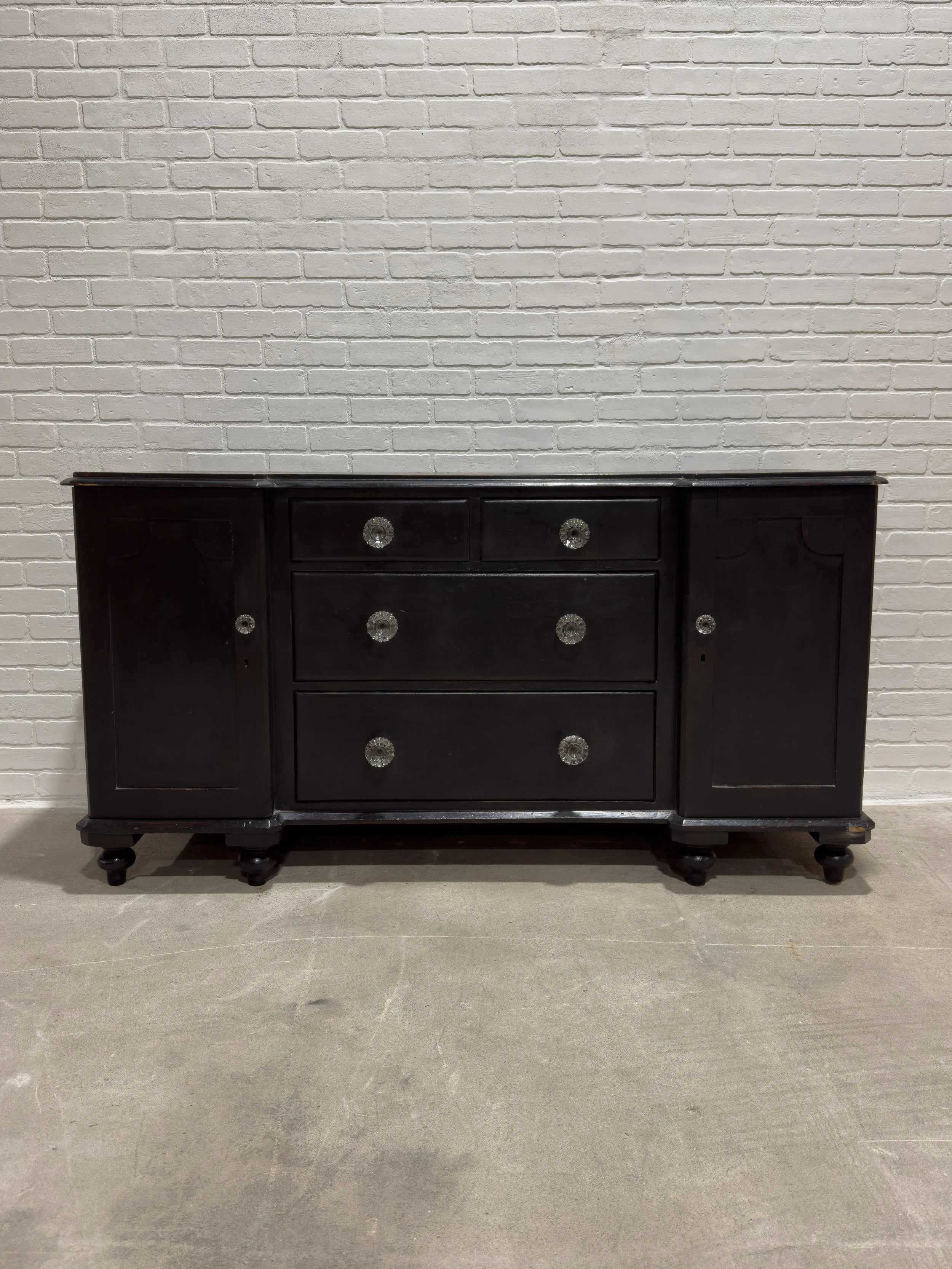 Ebonized English sideboard with glass knobs