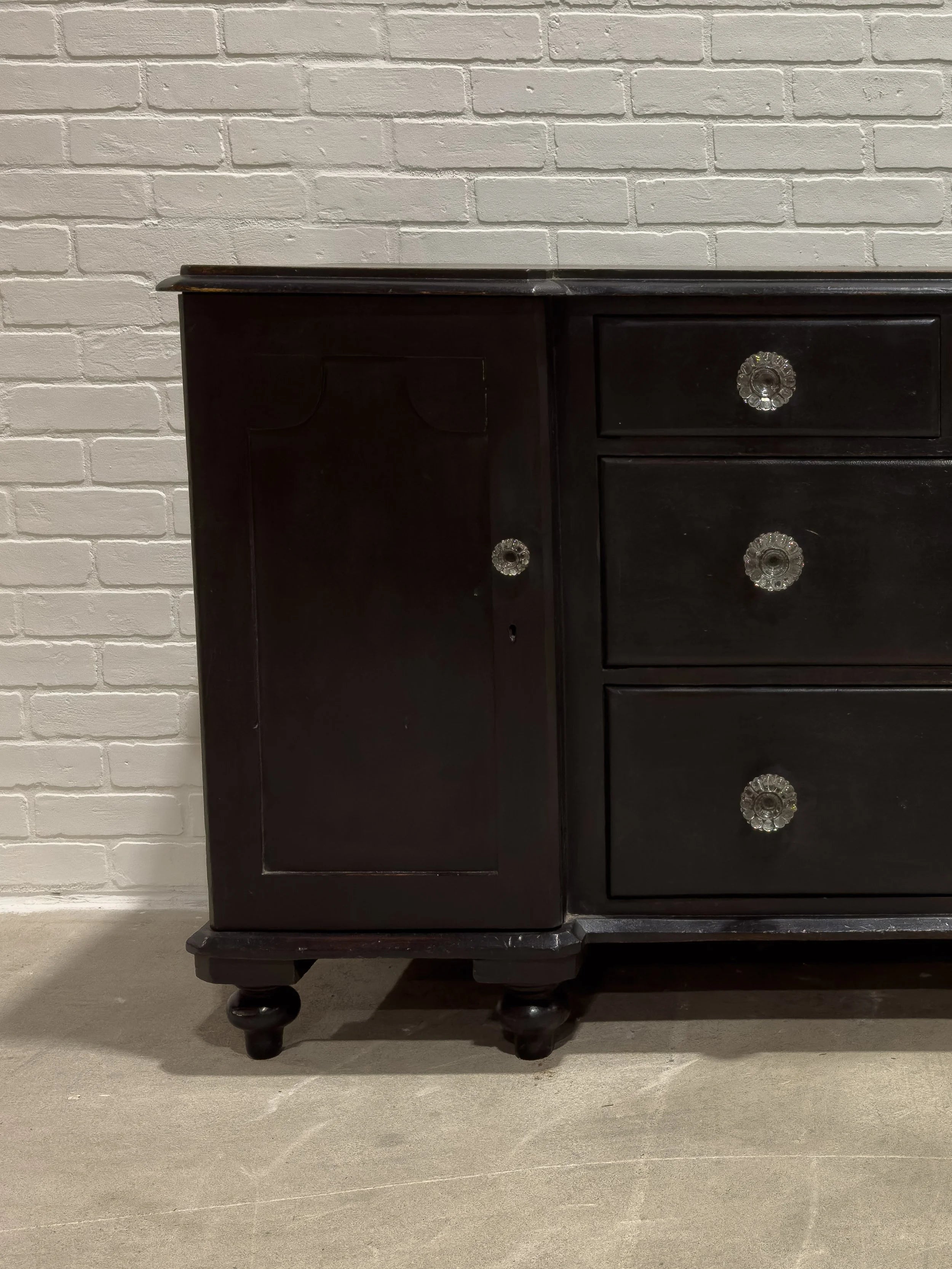 Ebonized English sideboard with glass knobs