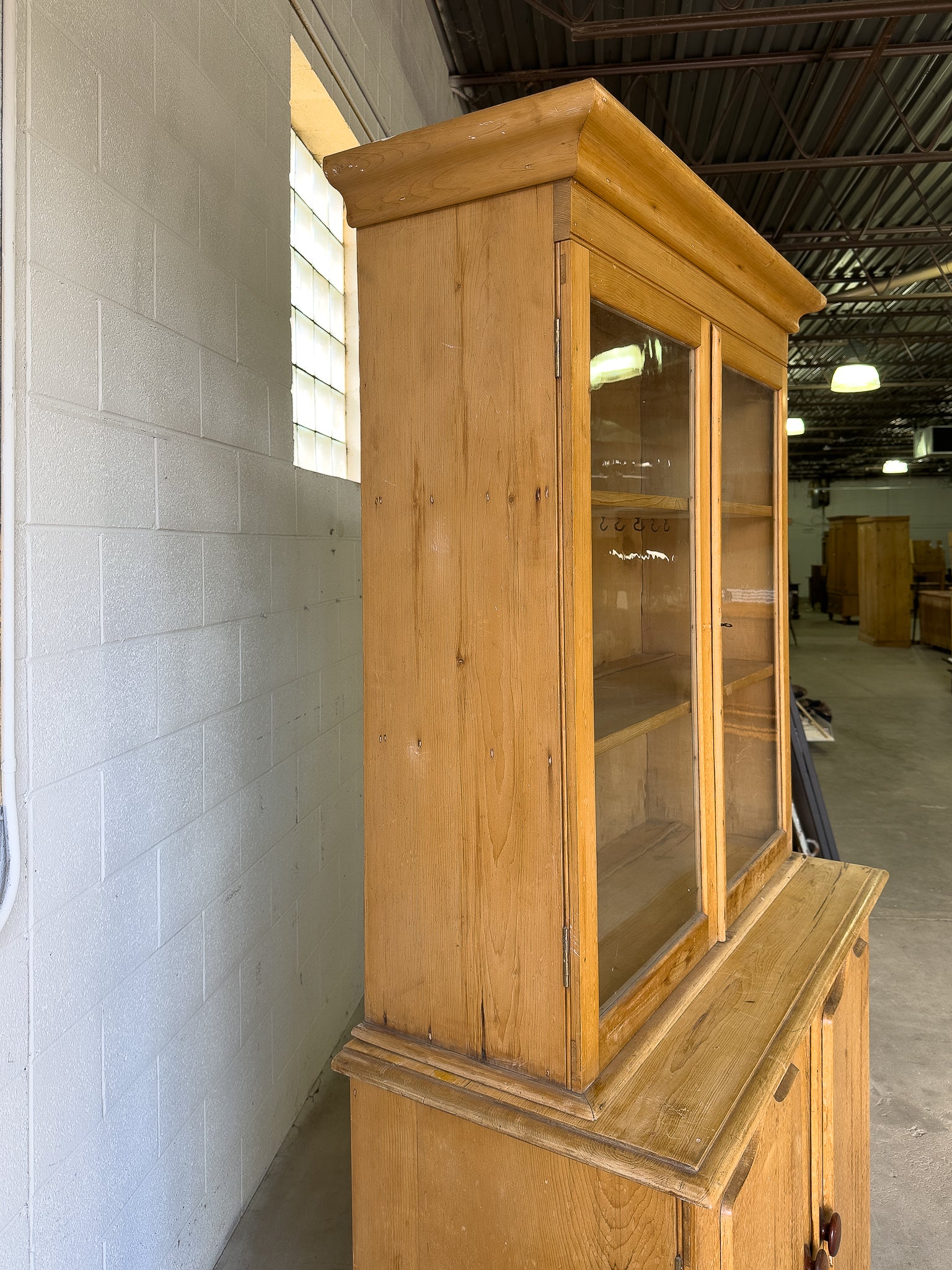Antique English pine cupboard with wavy glass
