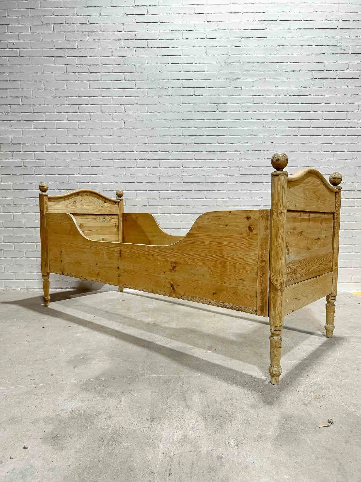 Narrow English pine sleigh bed