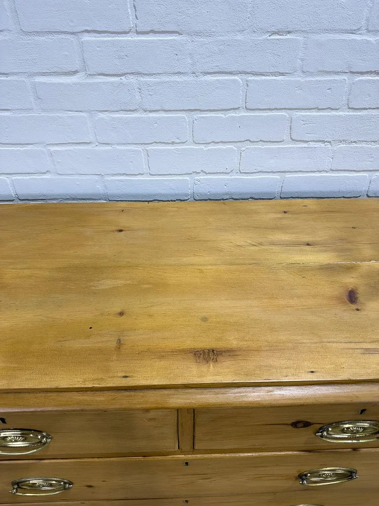 Antique English pine dresser with oval brasses