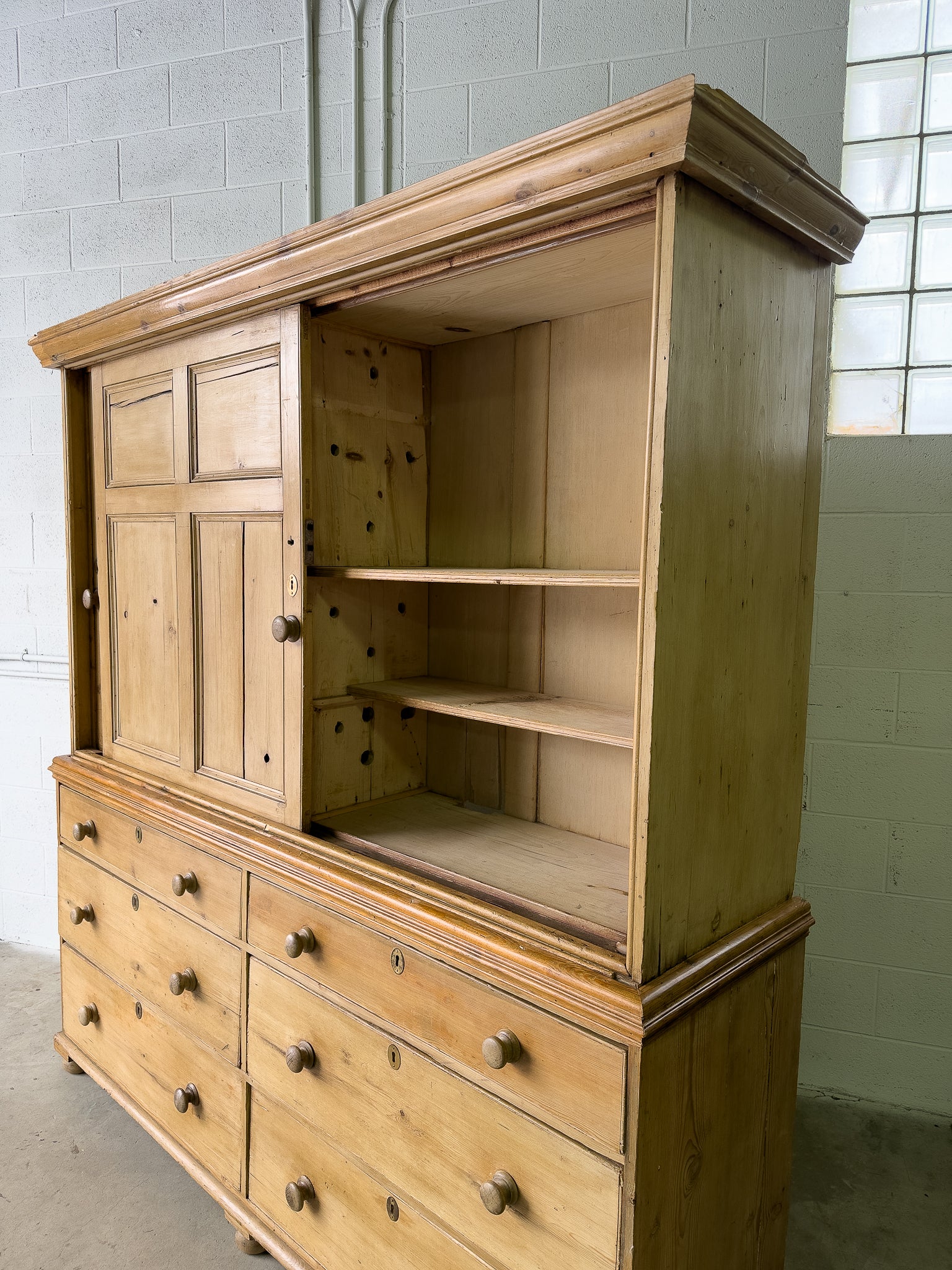 Large antique pine housekeepers cupboard with sliding doors