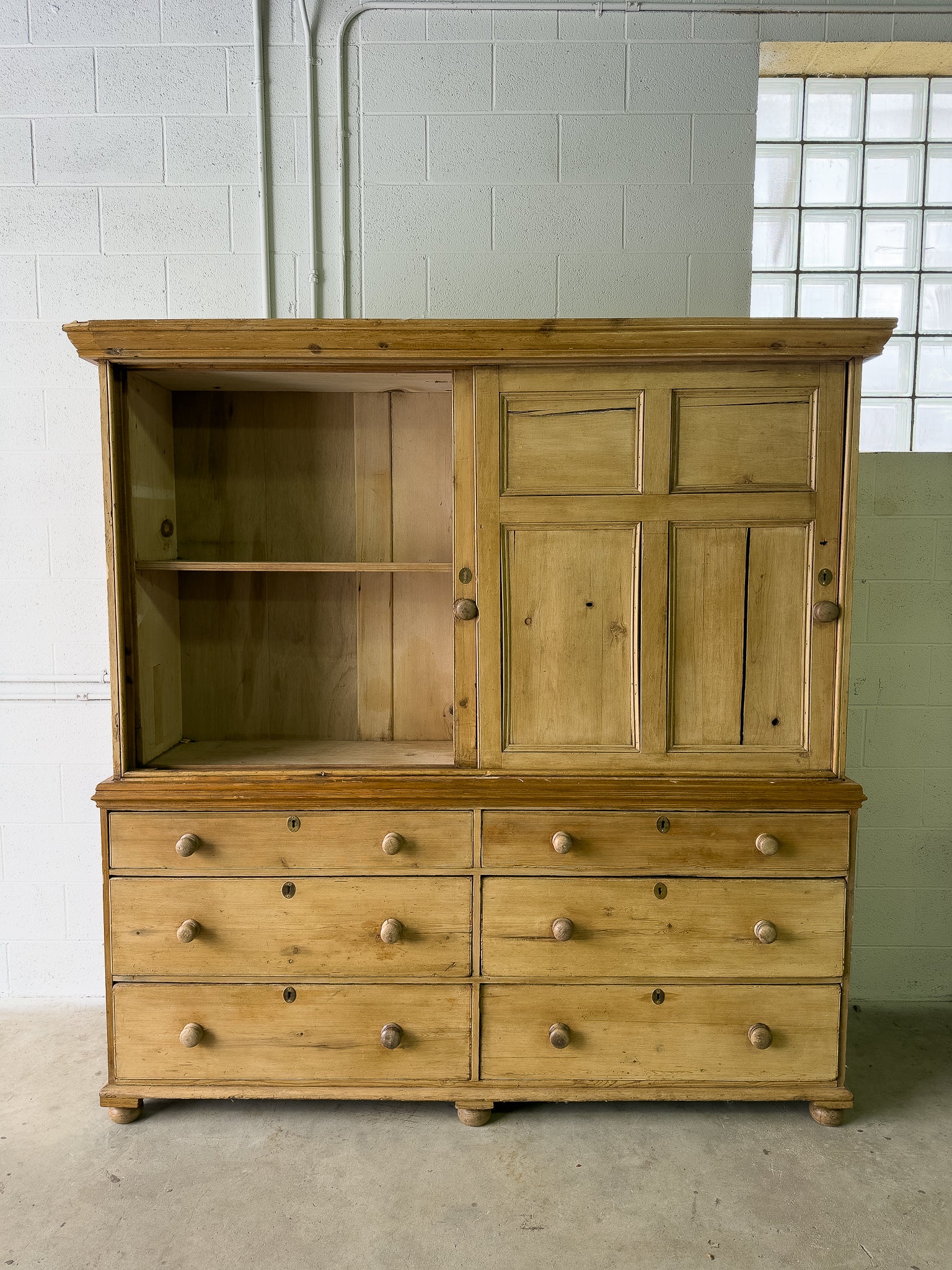 Large antique pine housekeepers cupboard with sliding doors