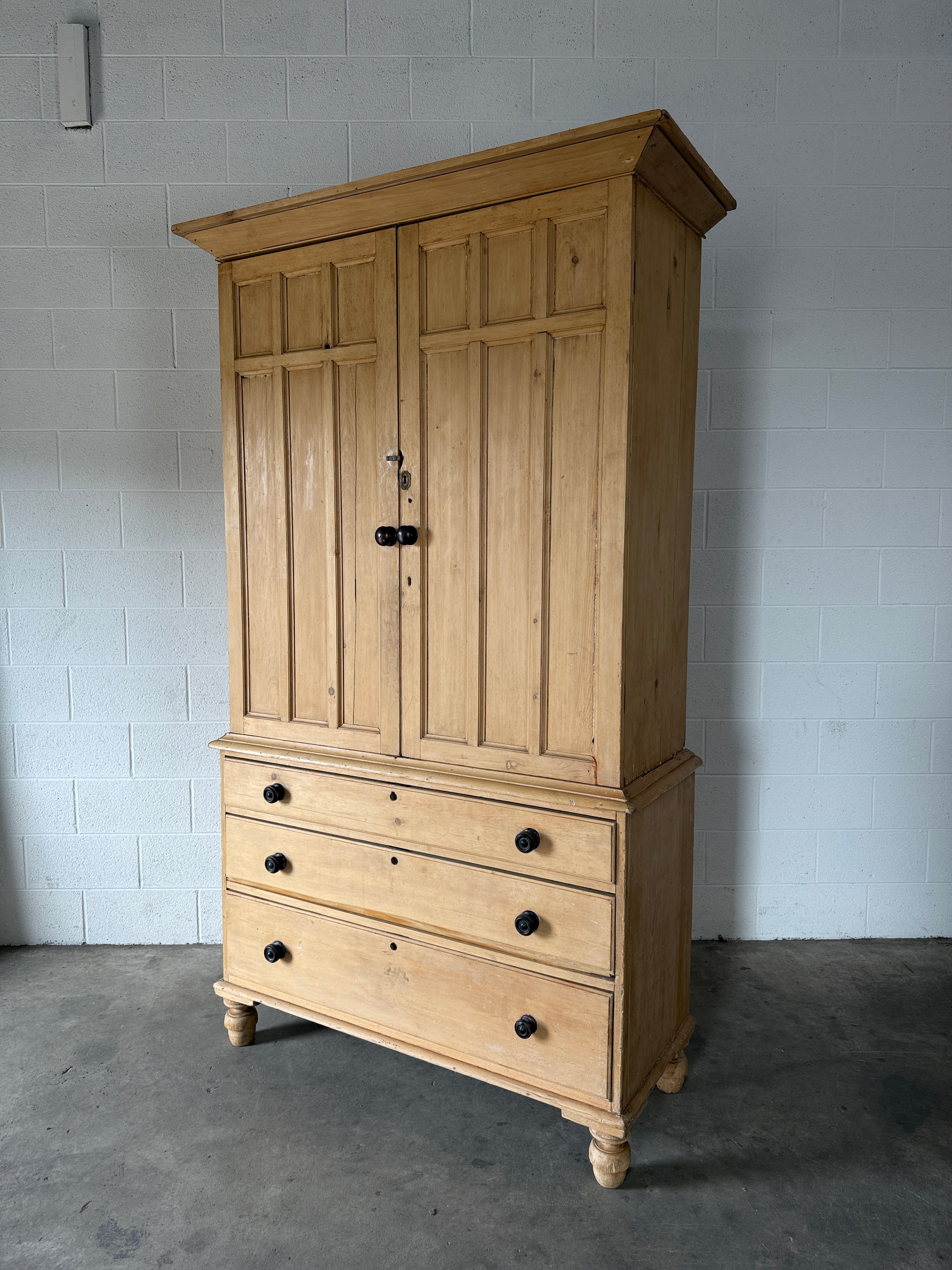 Antique English pine linen press with paneled doors