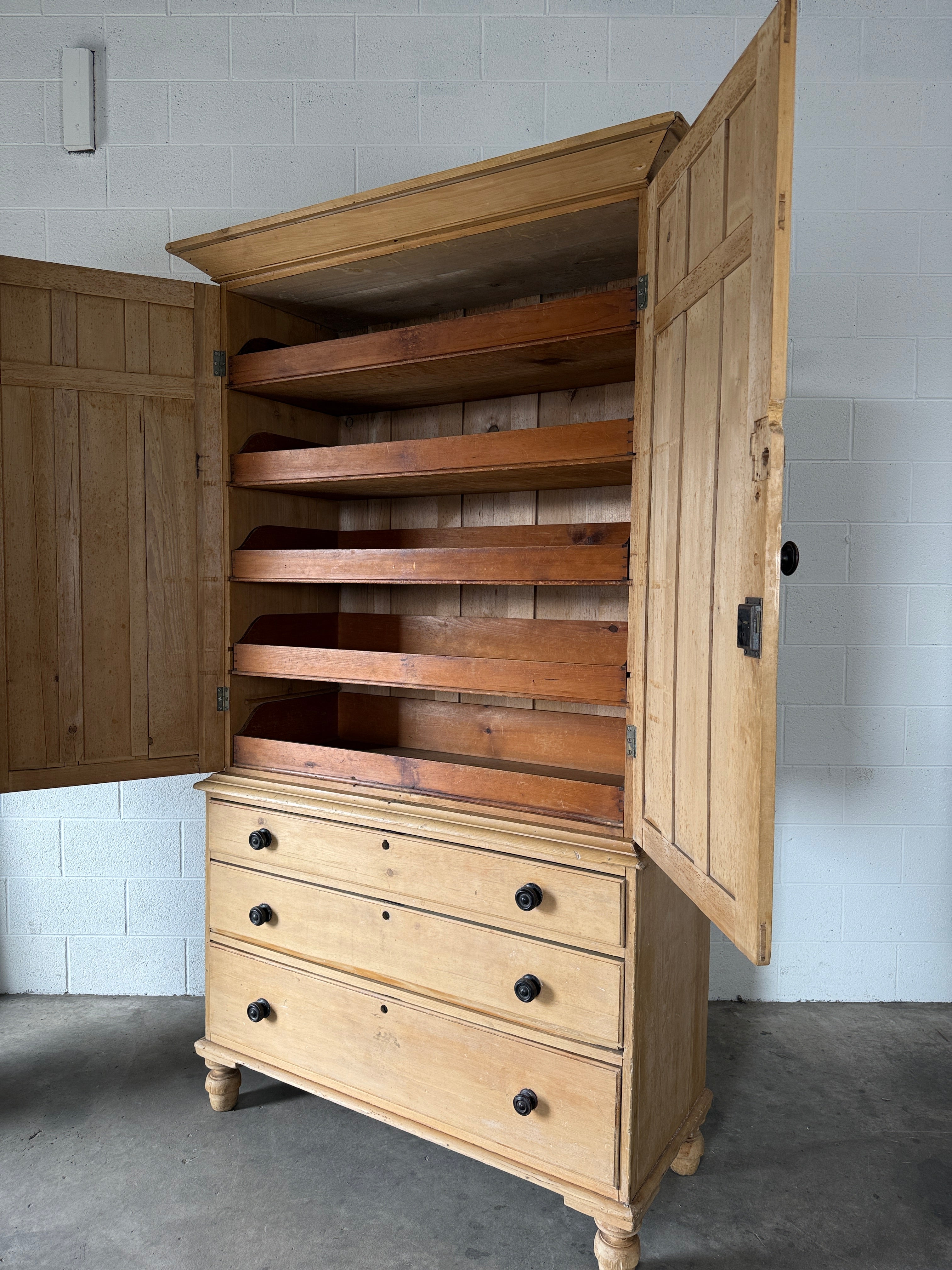 Antique English pine linen press with paneled doors