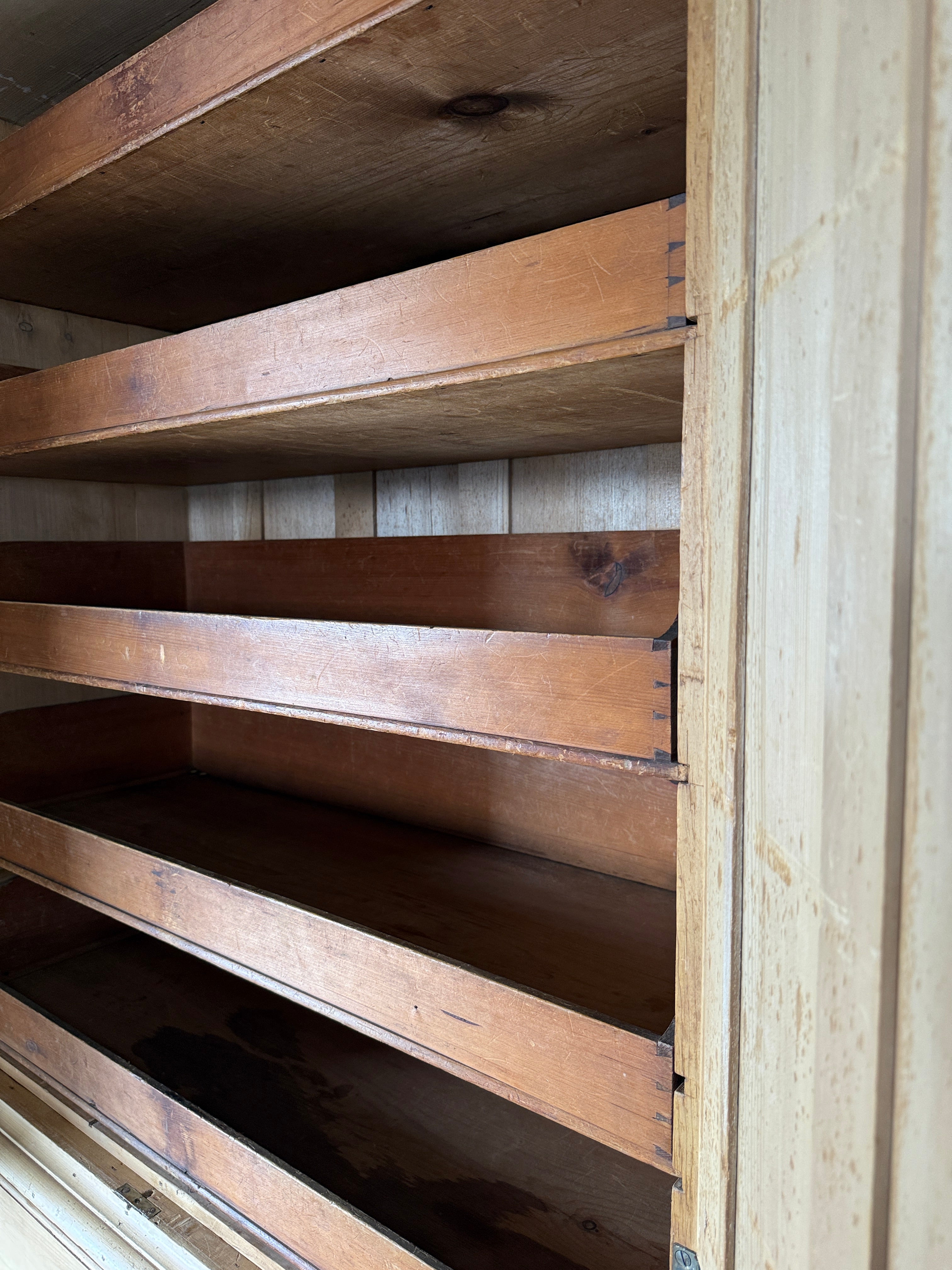 Antique English pine linen press with paneled doors