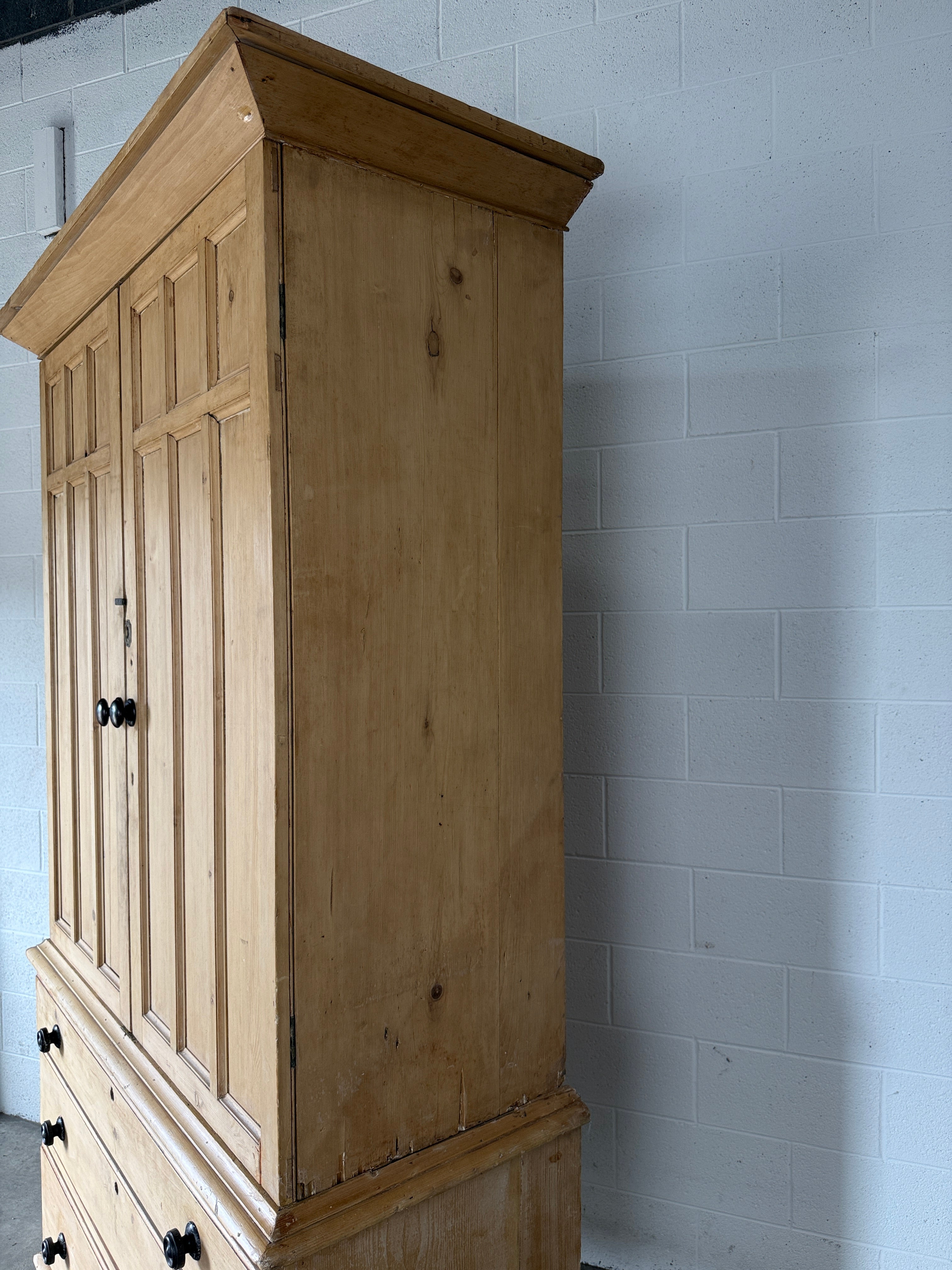 Antique English pine linen press with paneled doors