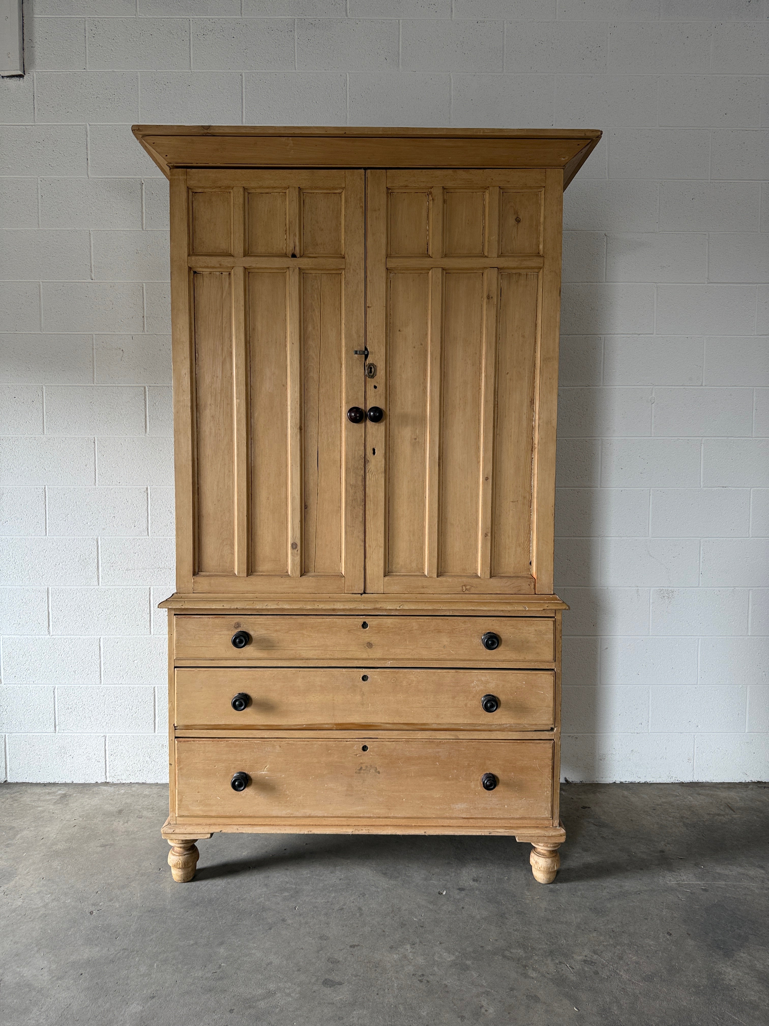 Antique English pine linen press with paneled doors