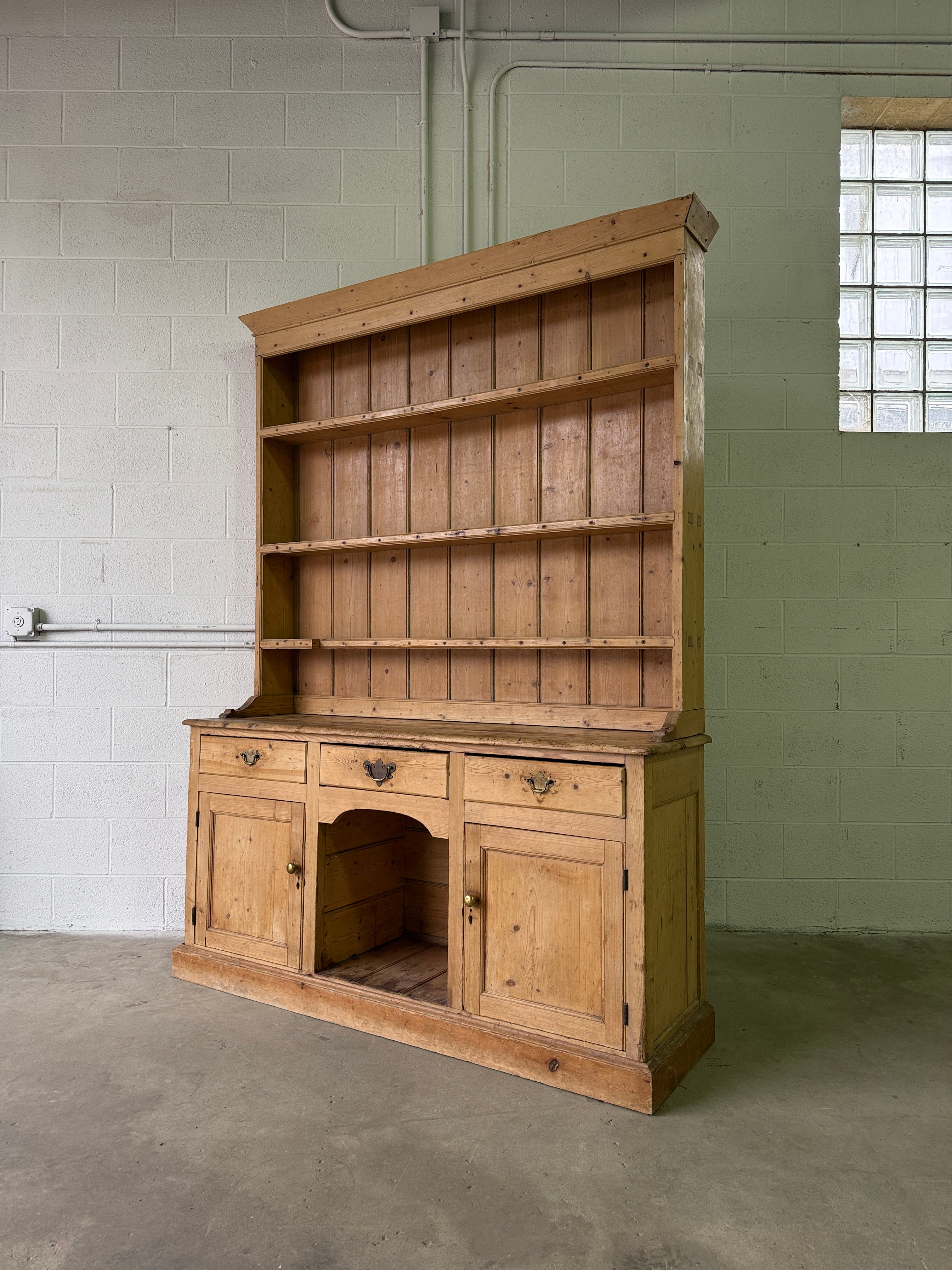 Striking antique pine kitchen dresser with brass pulls