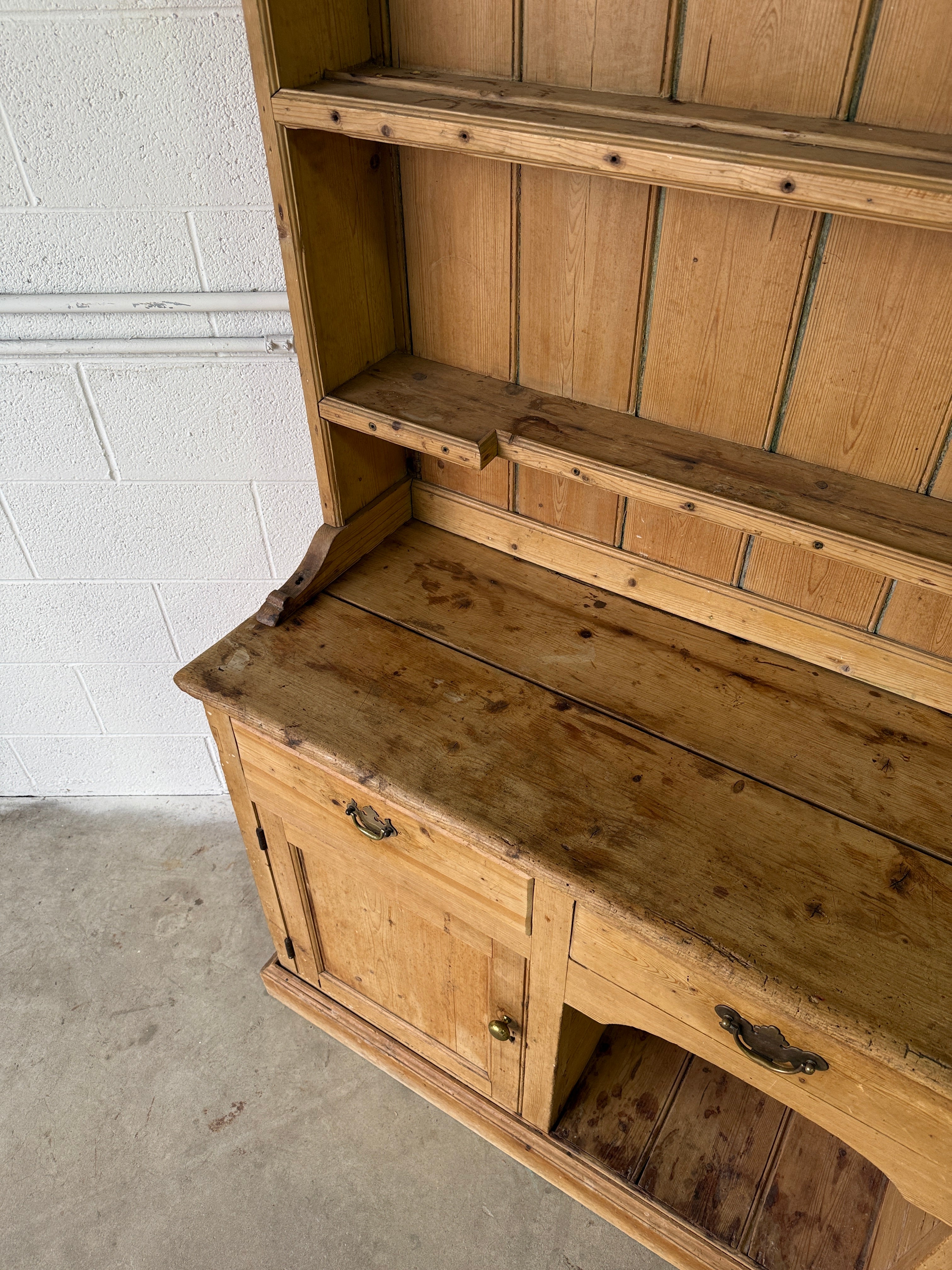 Striking antique pine kitchen dresser with brass pulls