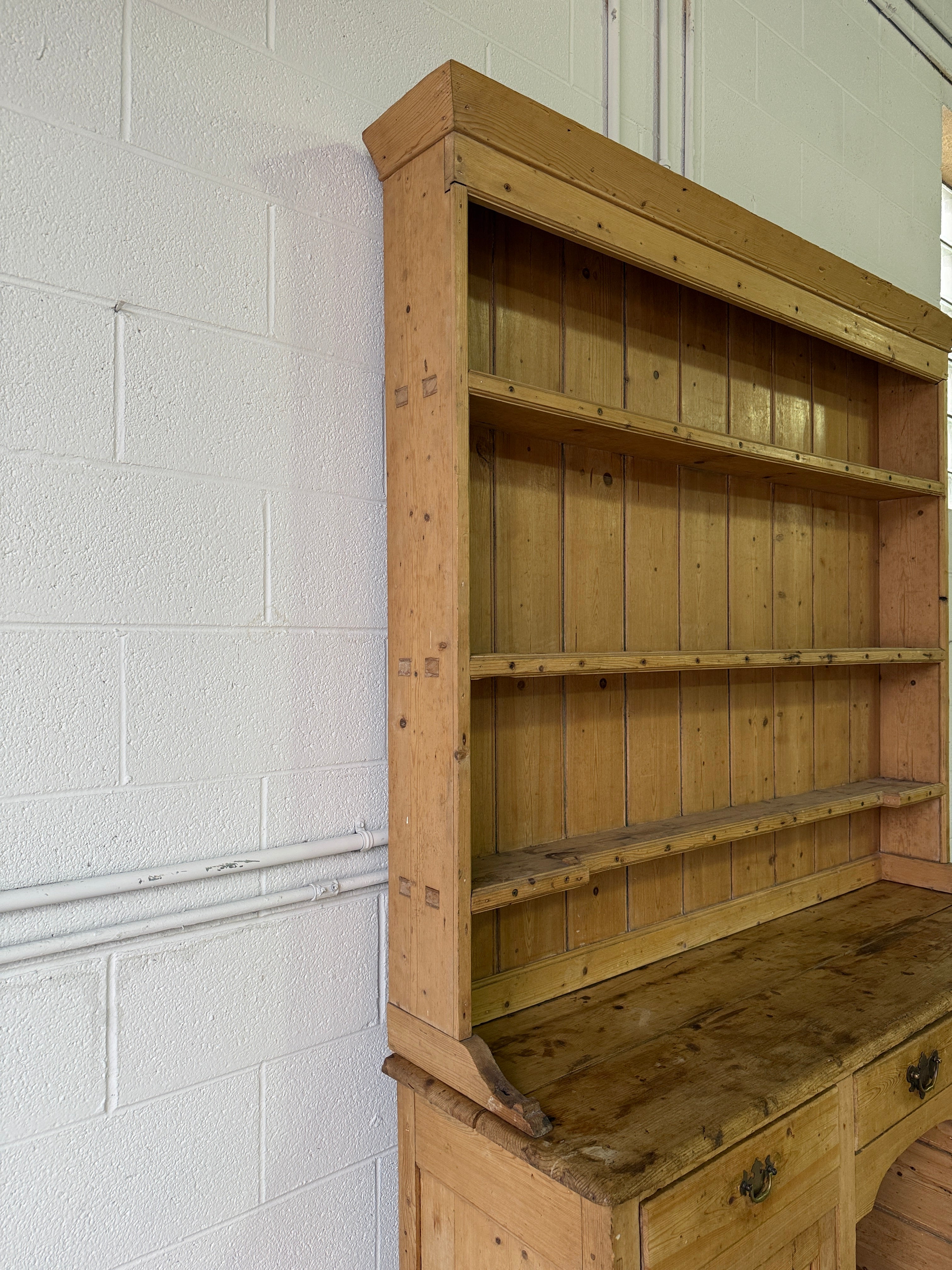 Striking antique pine kitchen dresser with brass pulls