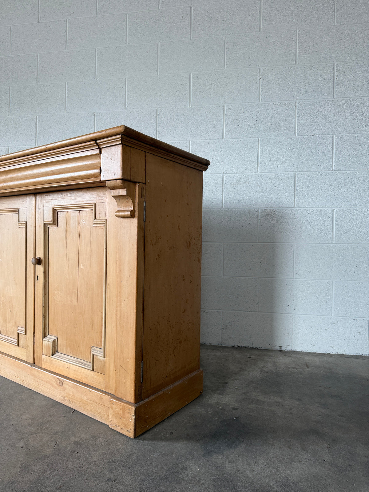 Antique European pine cupboard with hidden upper drawer