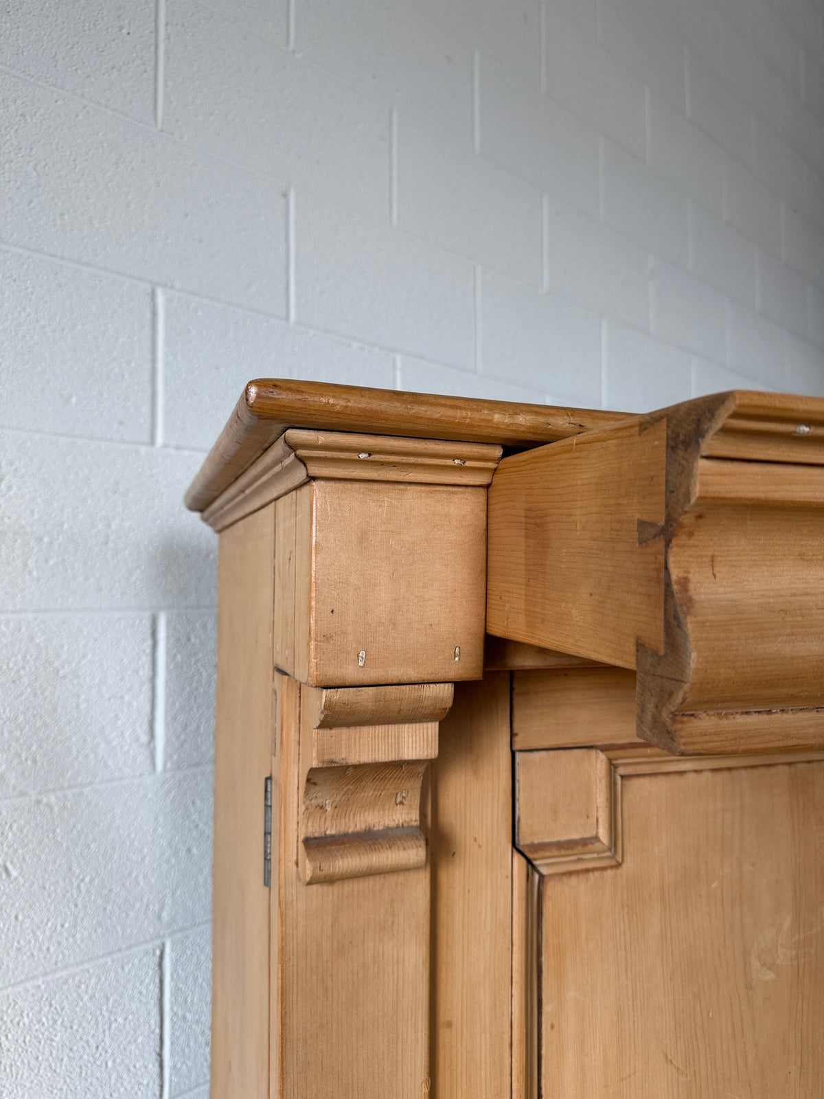 Antique European pine cupboard with hidden upper drawer