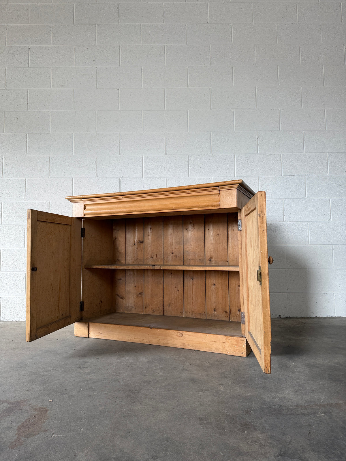 Antique European pine cupboard with hidden upper drawer