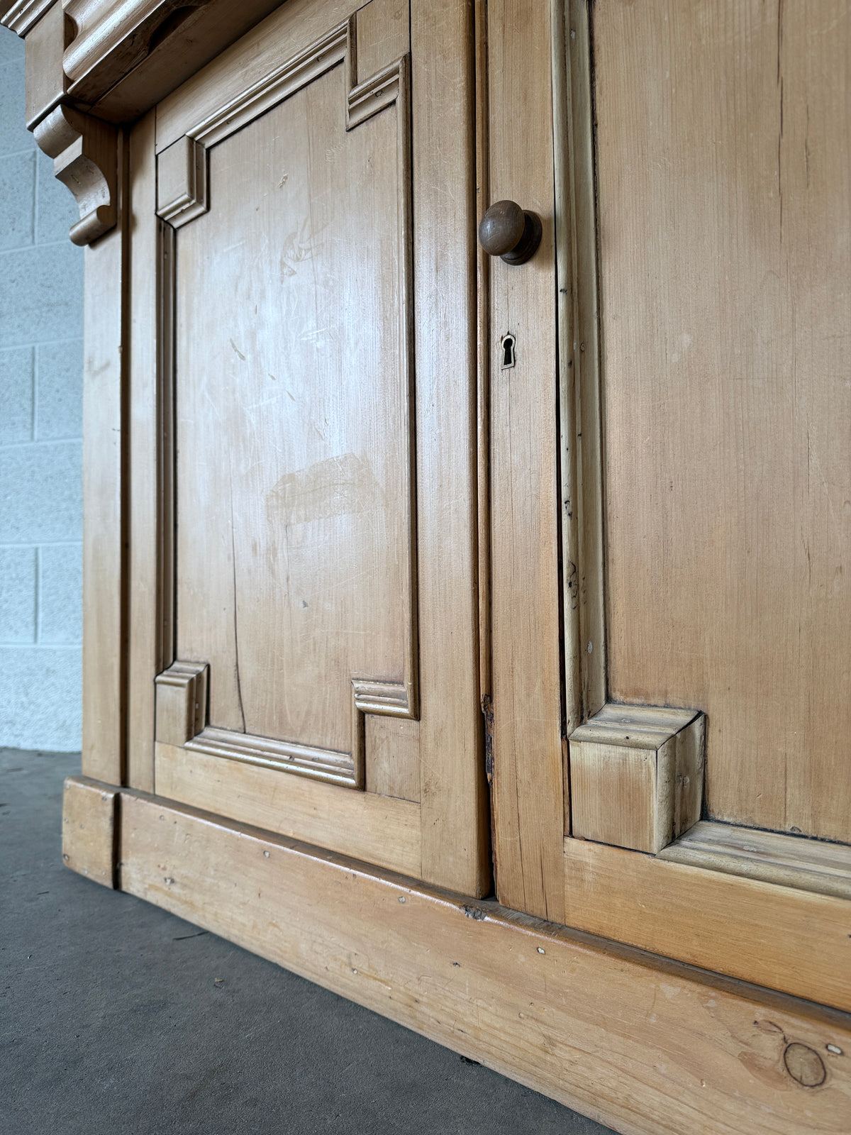 Antique European pine cupboard with hidden upper drawer