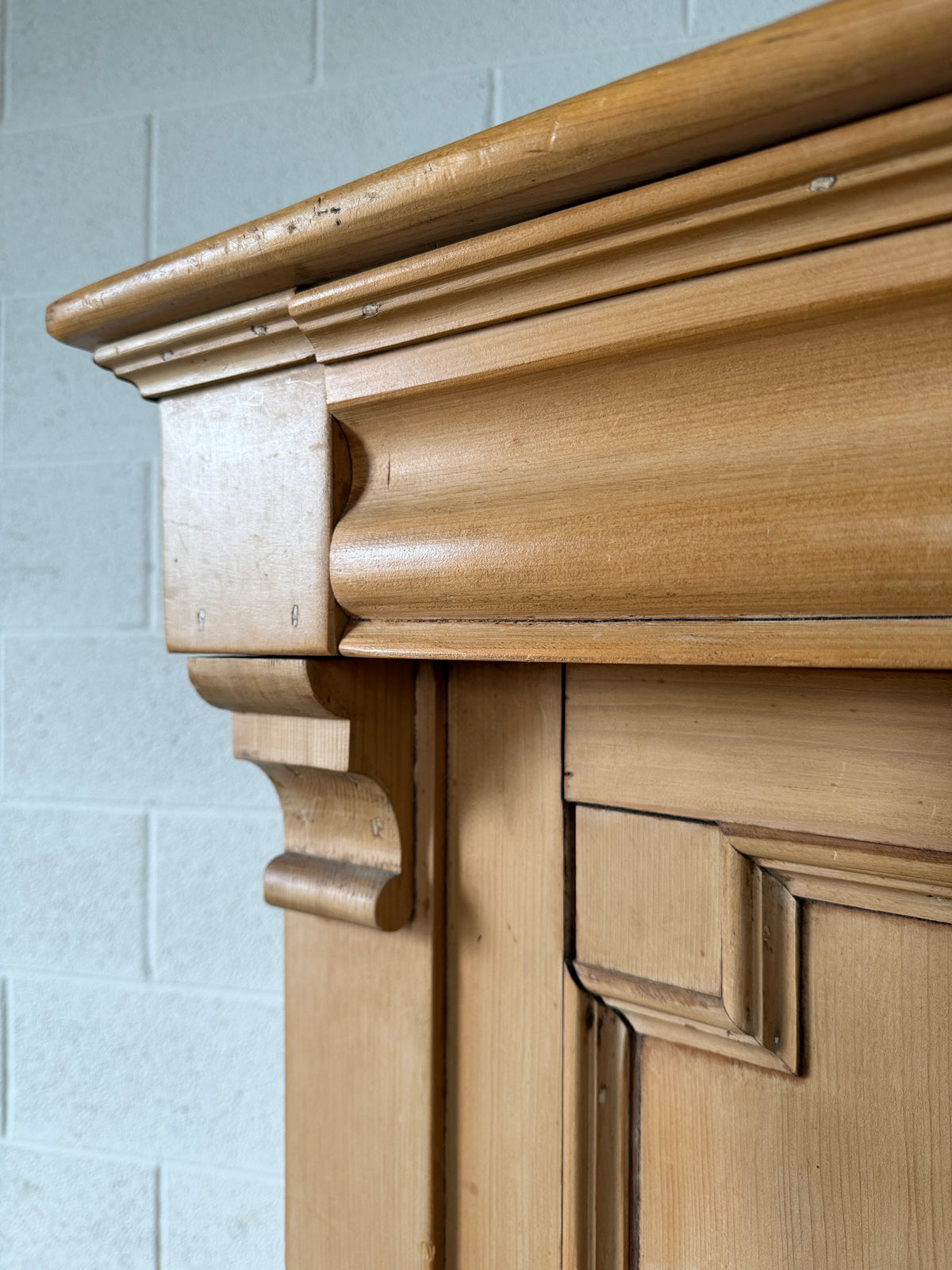 Antique European pine cupboard with hidden upper drawer