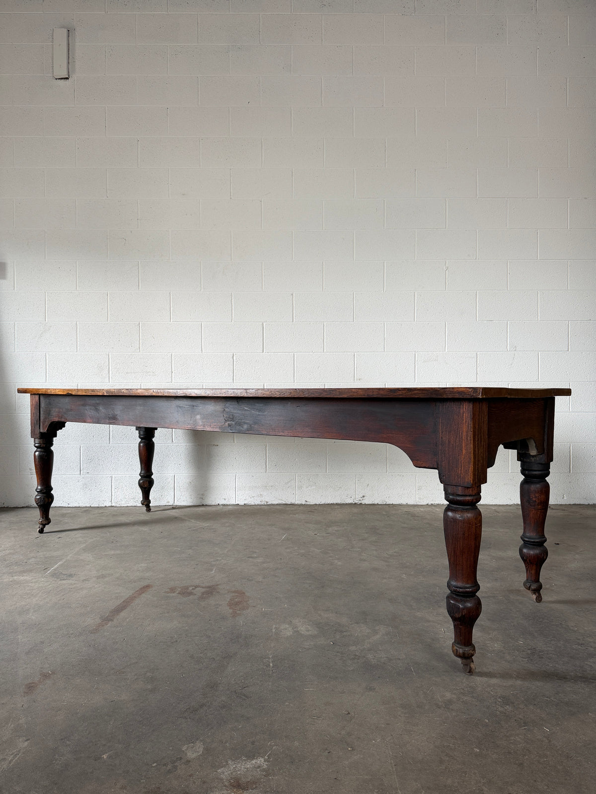 Victorian pine dining table with dark finish