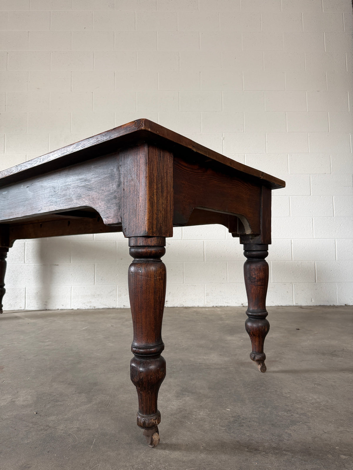 Victorian pine dining table with dark finish