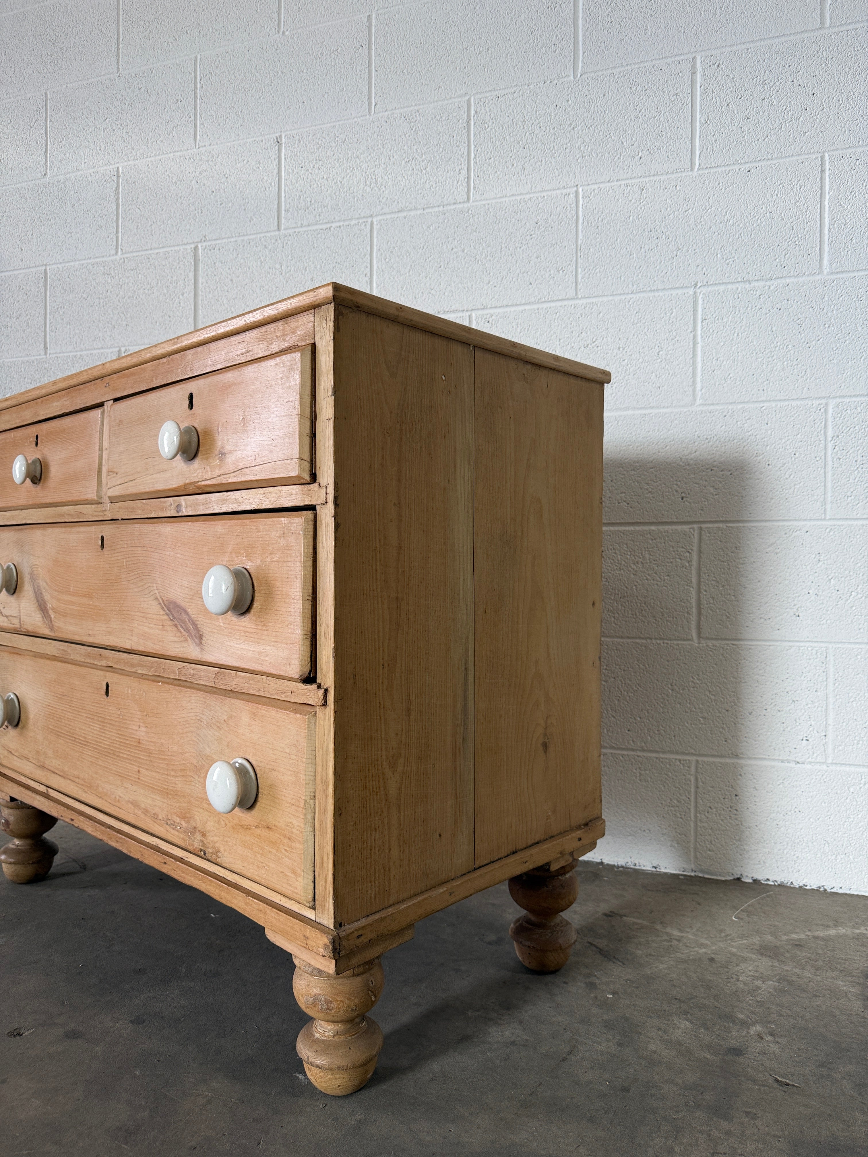 Petite pine chest of drawers with original porcelain knobs